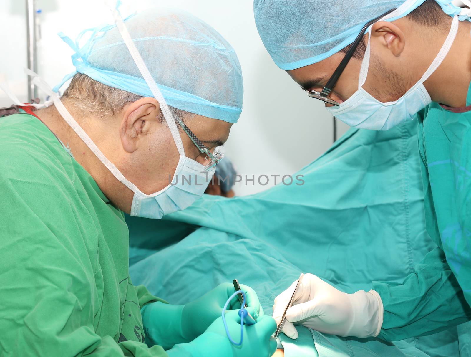 Surgeons working on a patient in operation room by dacasdo