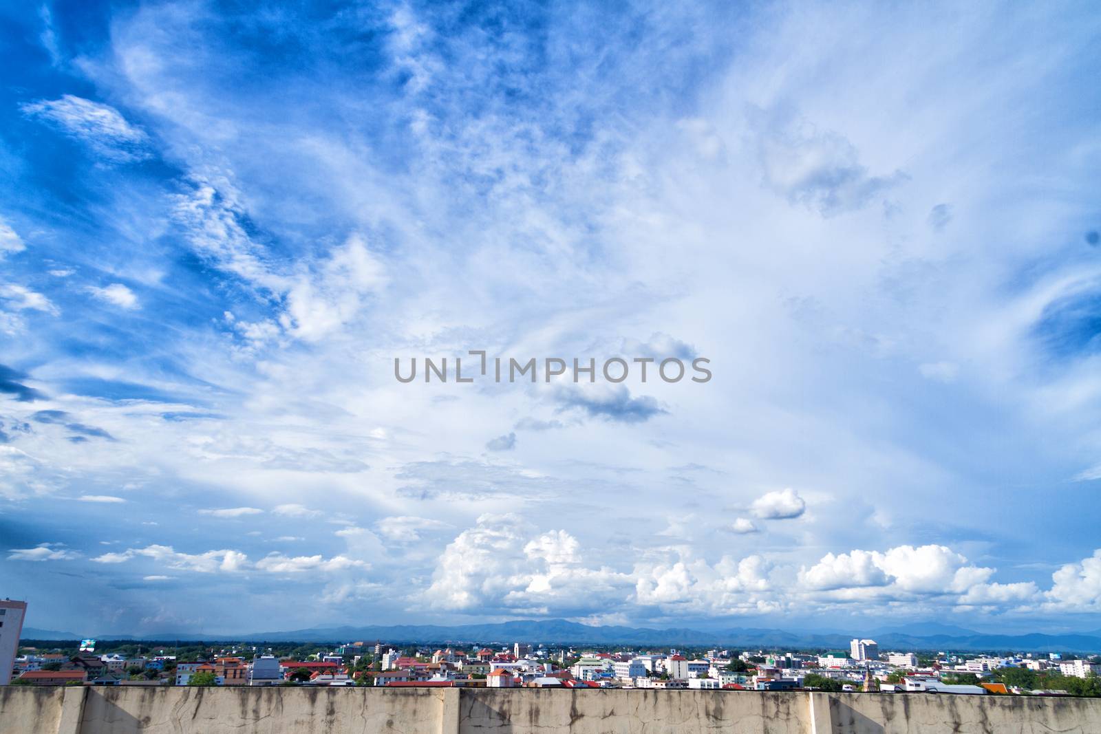blue sky background with tiny clouds and cityscape on top view by nopparats