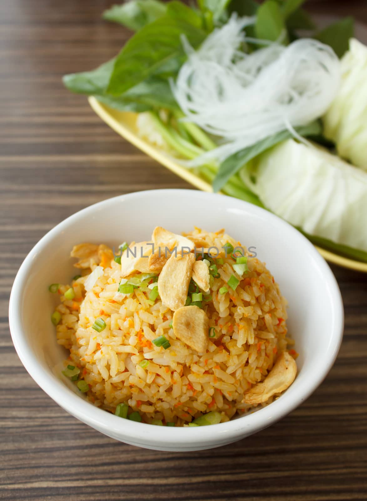 Fried rice with garlic on wooden table