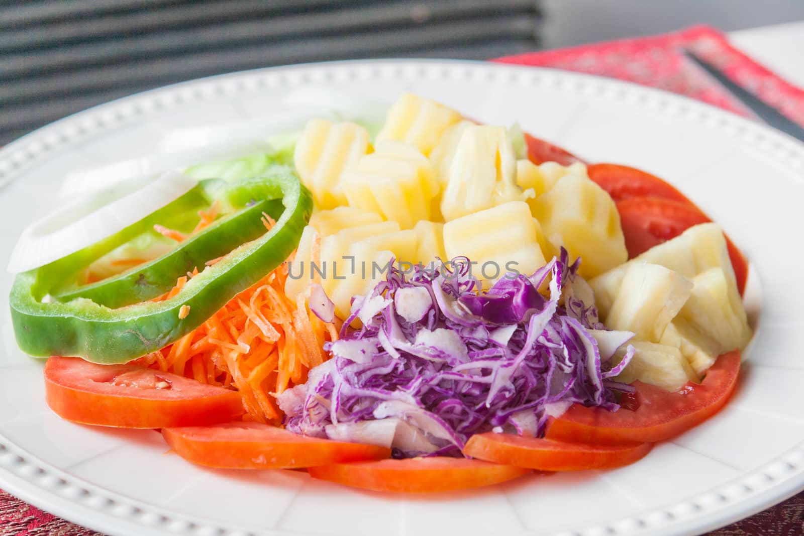 Fresh salad with tomatoes and cucumbers. on a table.