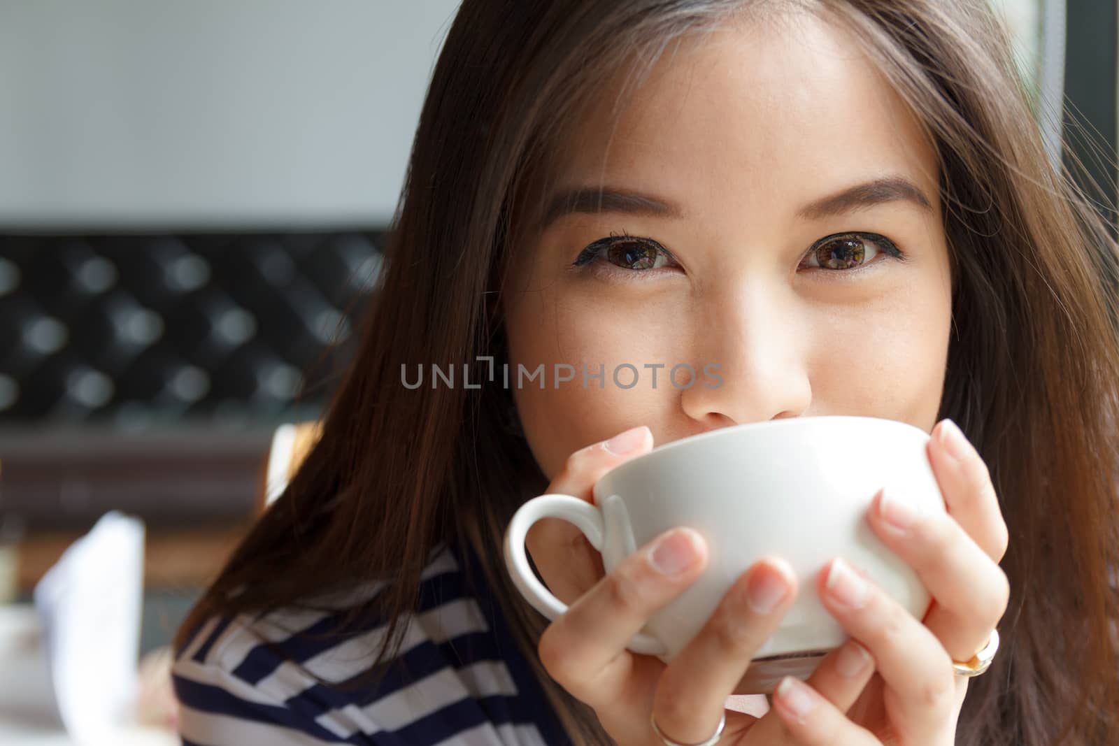 Close up portrait of woman drinking coffee by vitawin