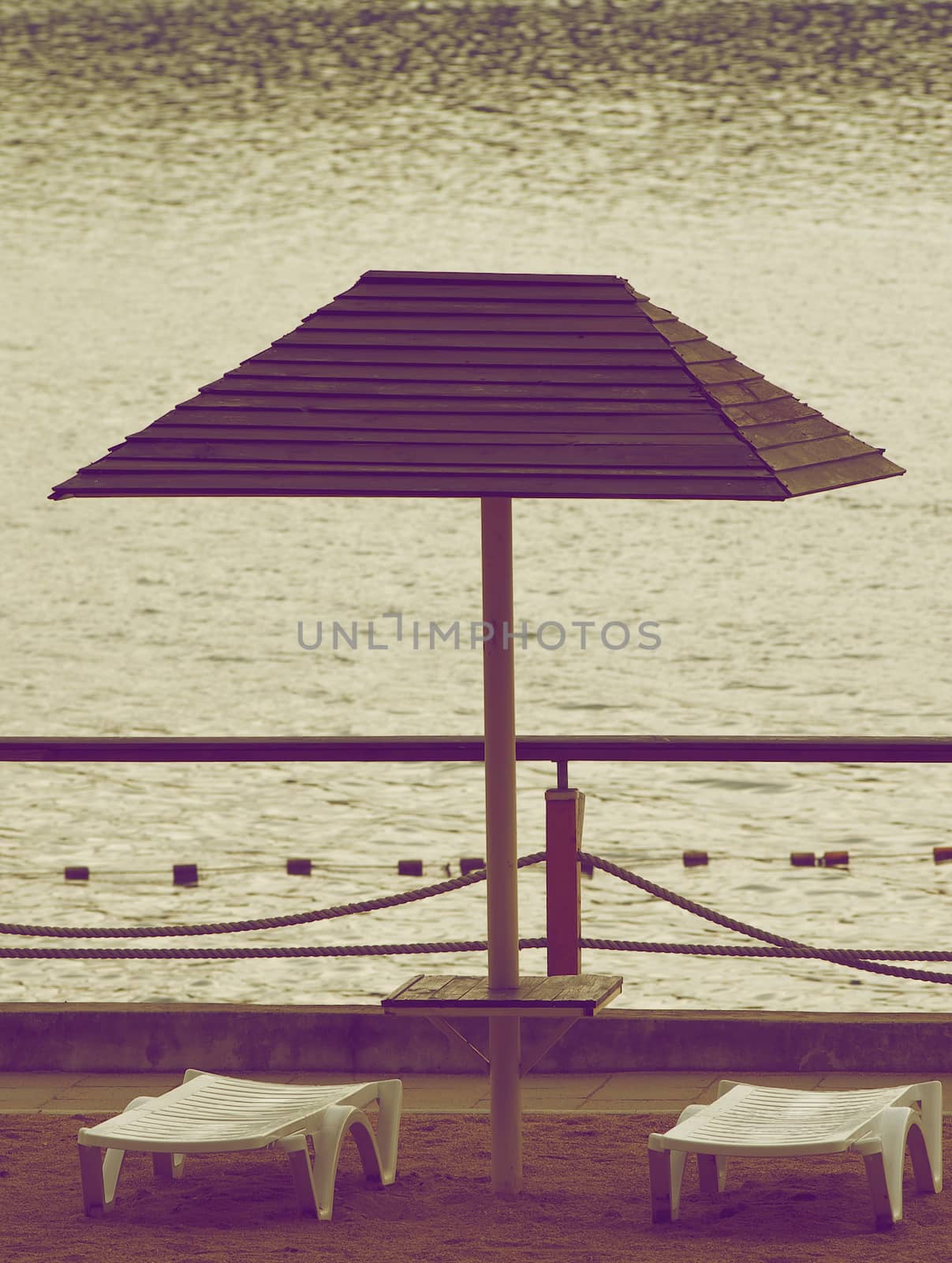Beach Chairs and Parasol in Cloudy Day Outdoors. Retro Styled
