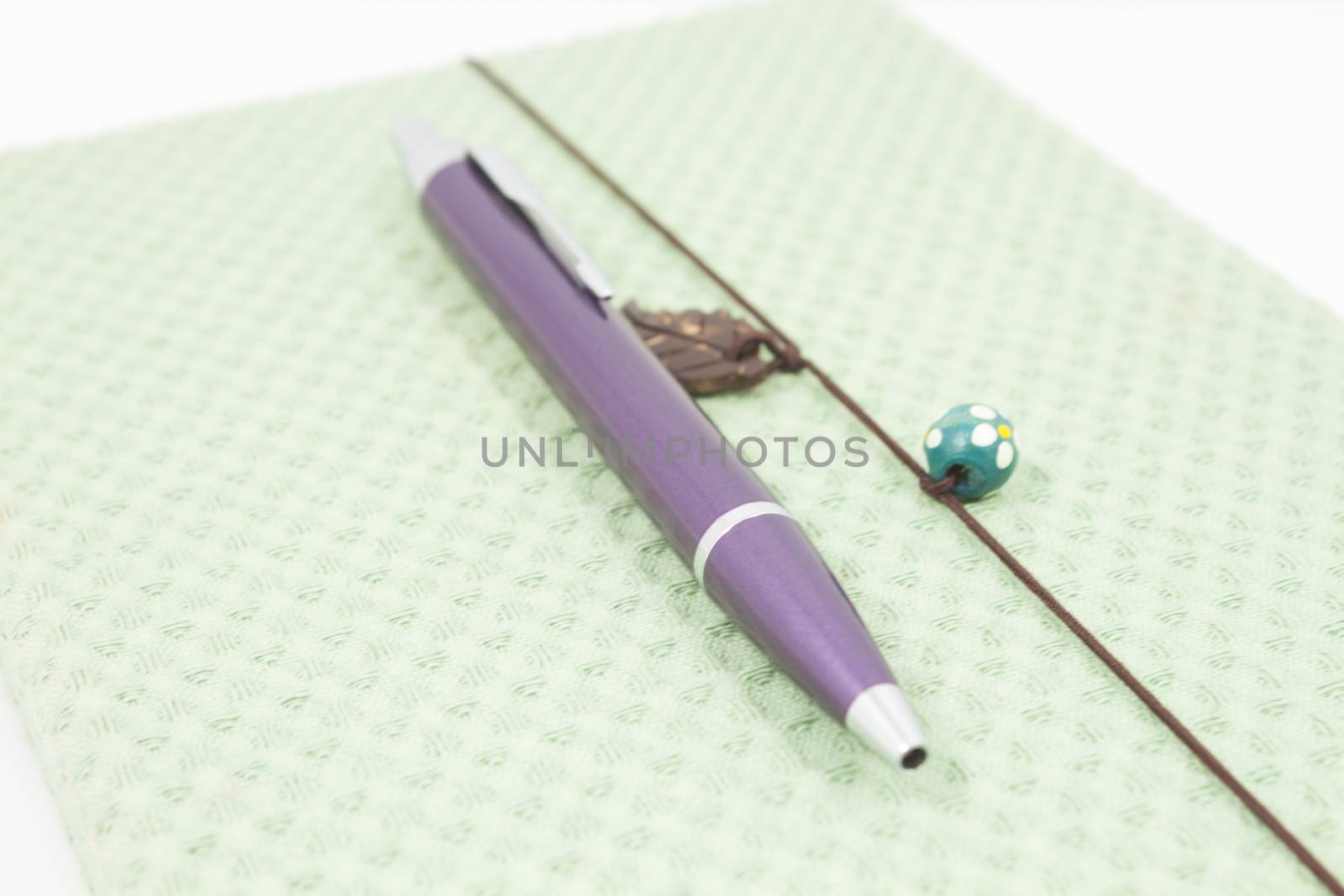 Closeup handmade notebook with pen isolated on white background, stock photo