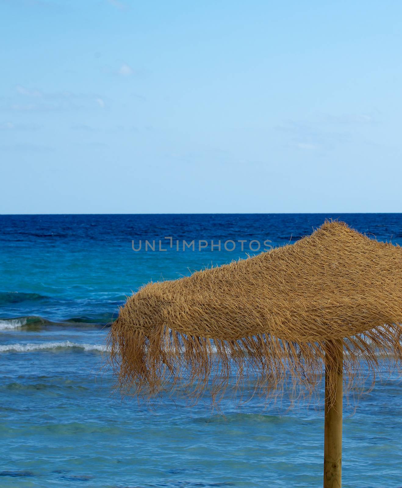 Thatched Umbrella Overlooking on Turquoise Sea Outdoors