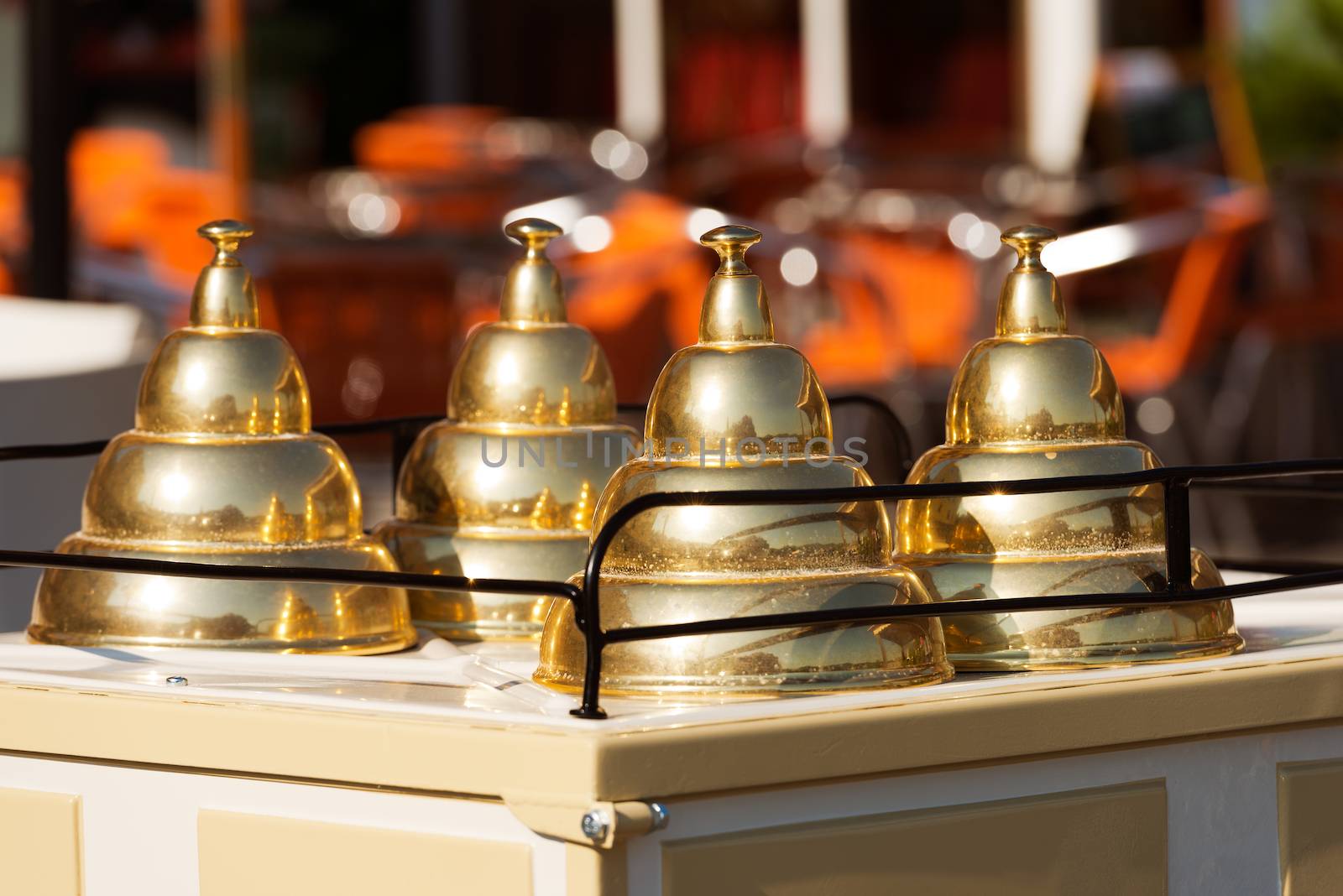 Close up of a italian ice cream cart with three lids golden pyramid shaped