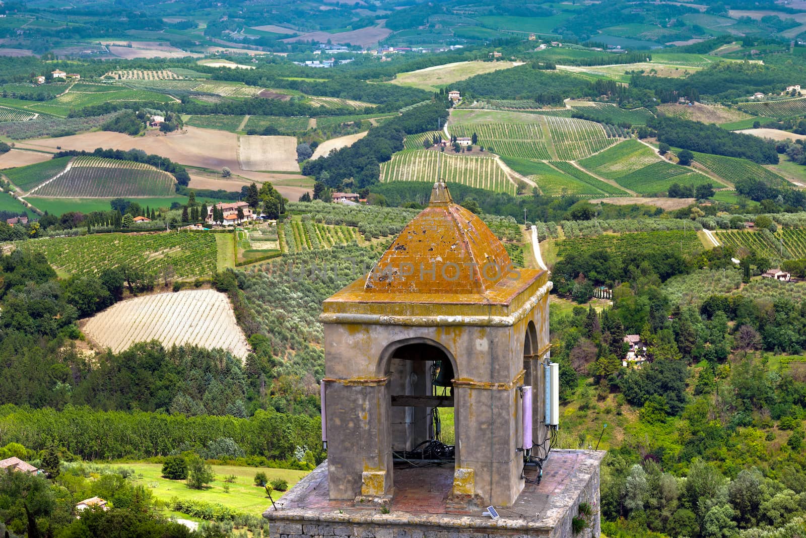 Bell tower and the Tuscan countryside, San Gimignano medieval town (UNESCO heritage), Siena, Tuscany, Italy