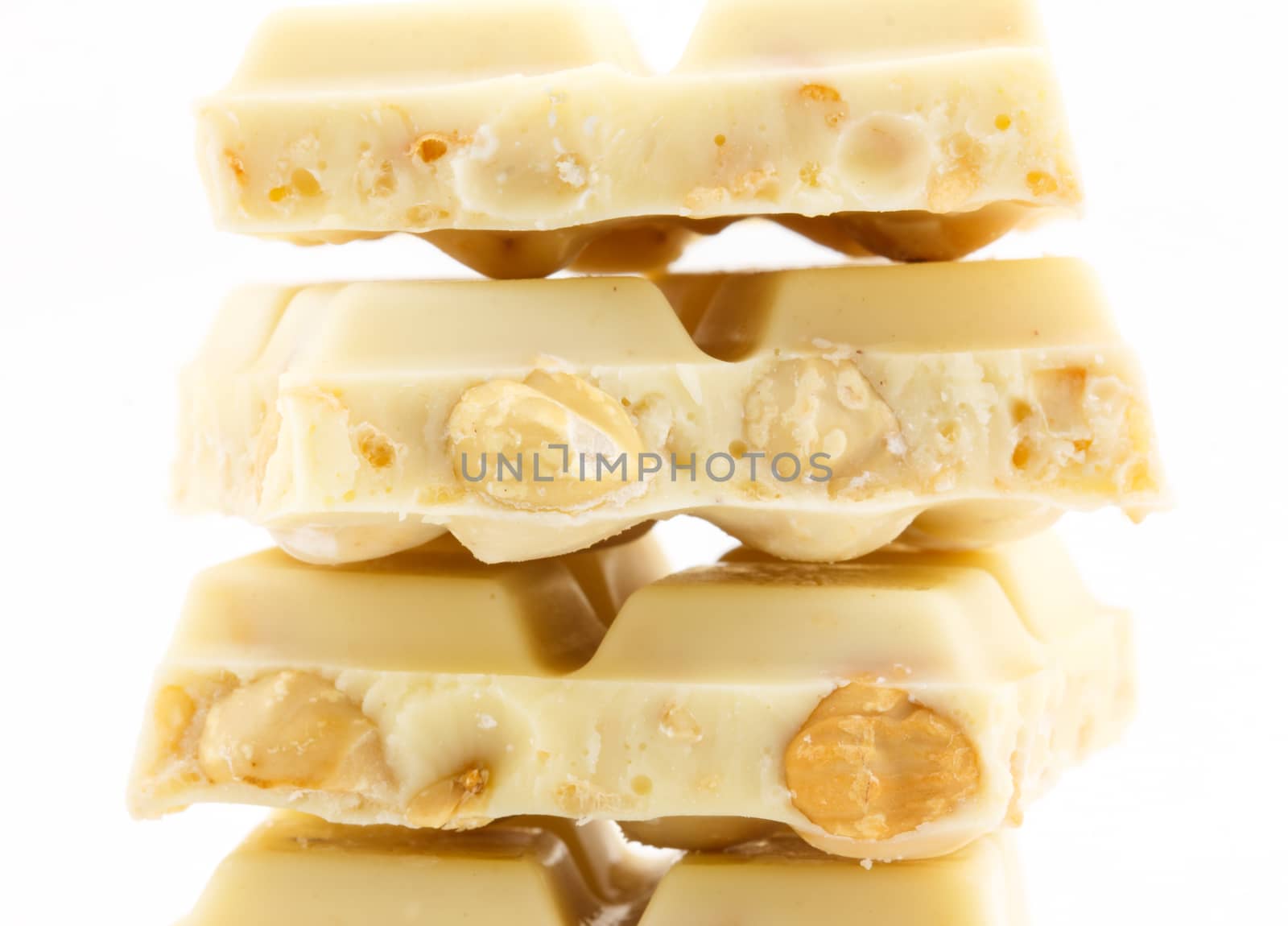close up of white chocolate with nut on white background