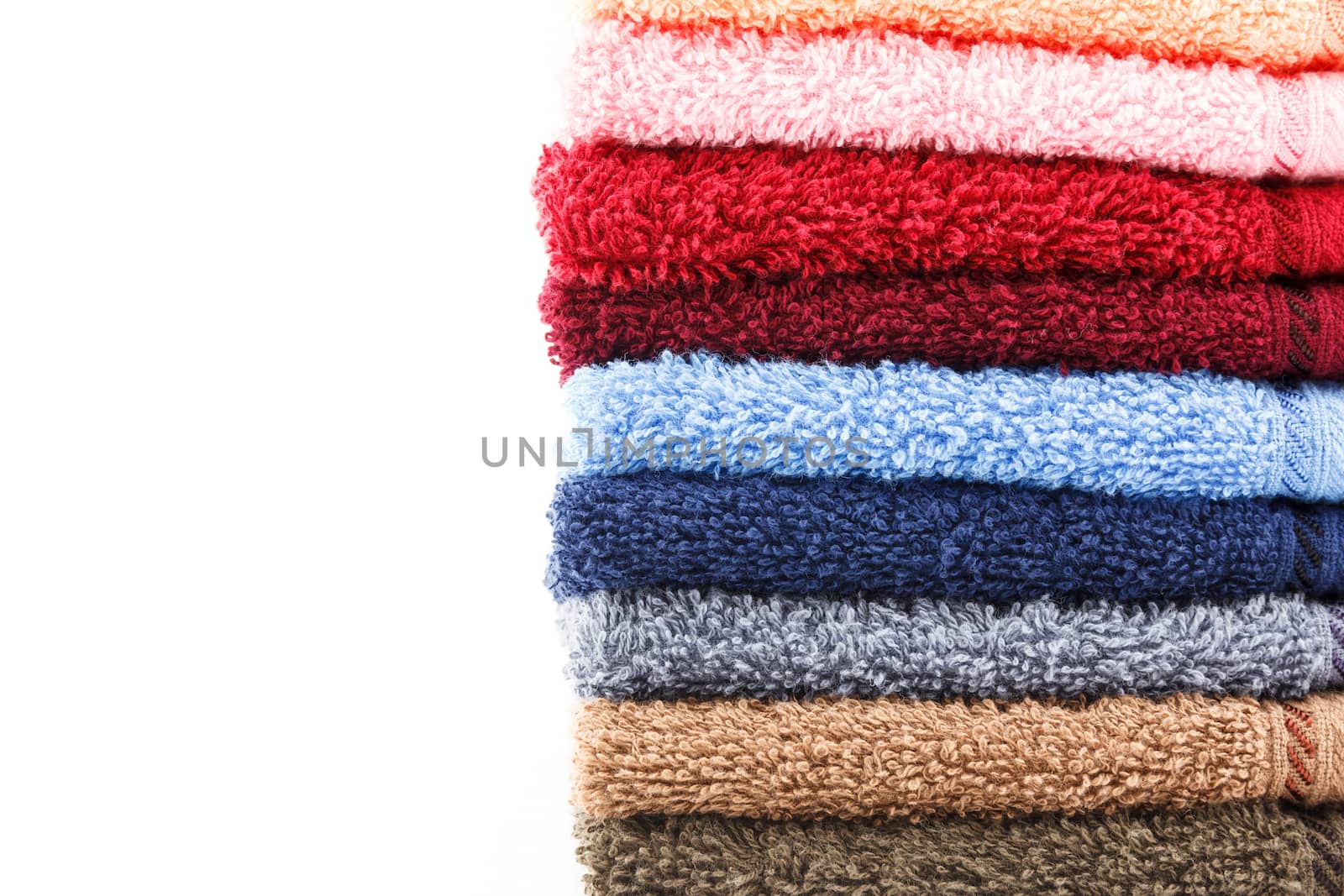 Stack of colorful towels isolated on white background