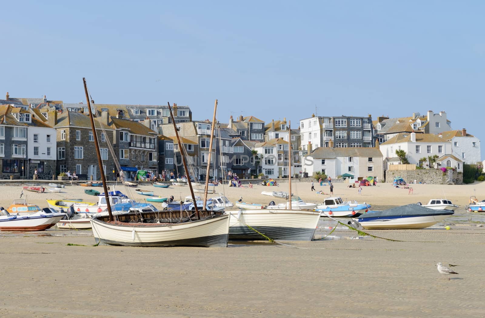 St Ives in Cornwall has boats on the beach on a sunny day in the summer