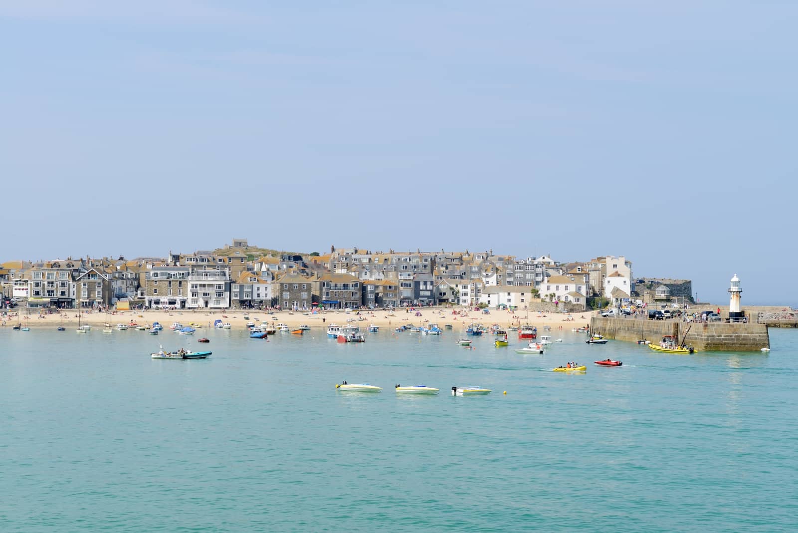 St Ives in Cornwall, England. Showing harbour with fishing boats on a sunny day in the summer.