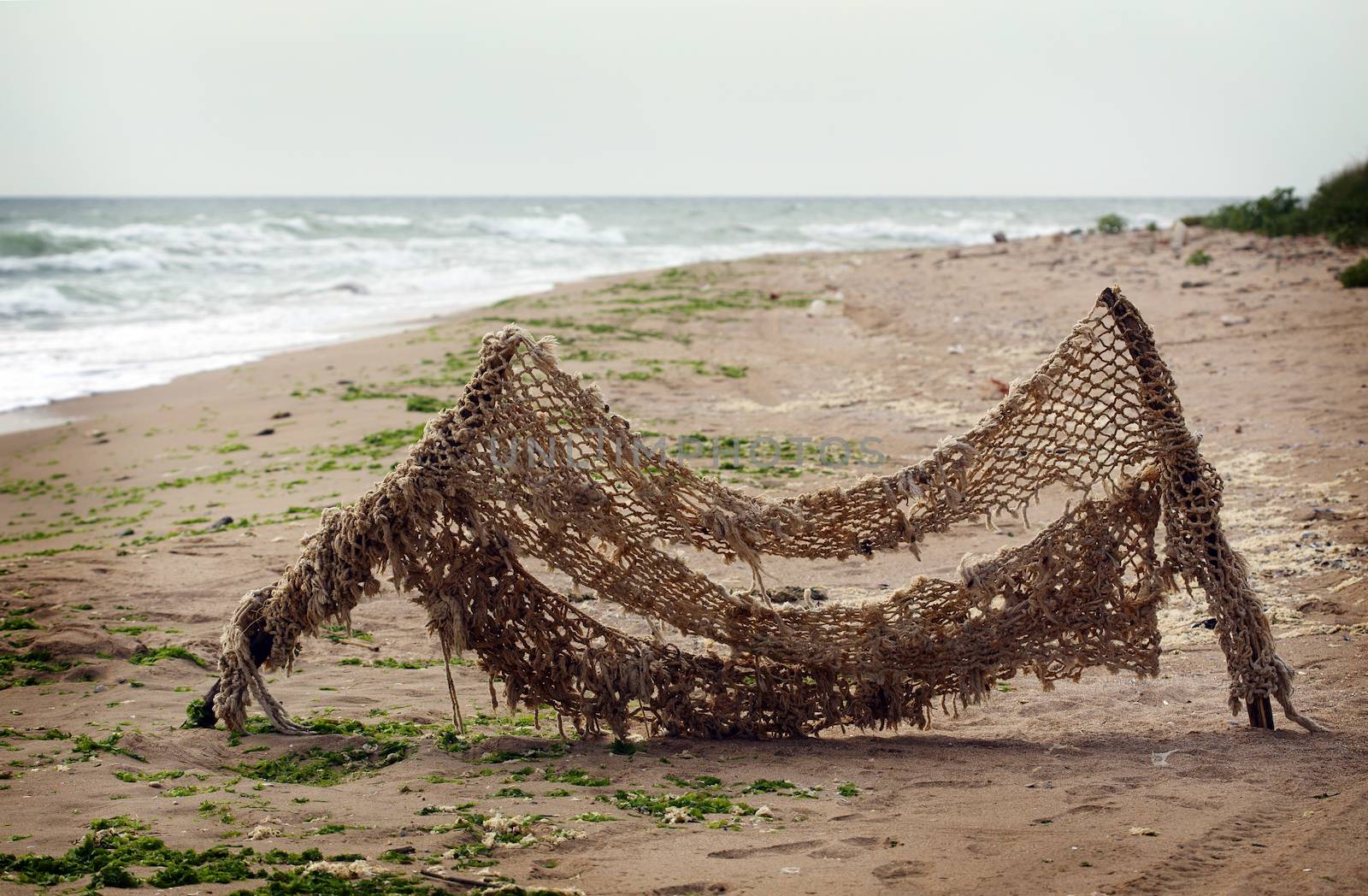 old fishing net stretched on the shore