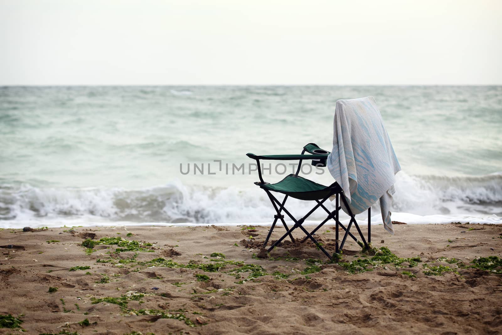 lone folding chair on the stormy coast