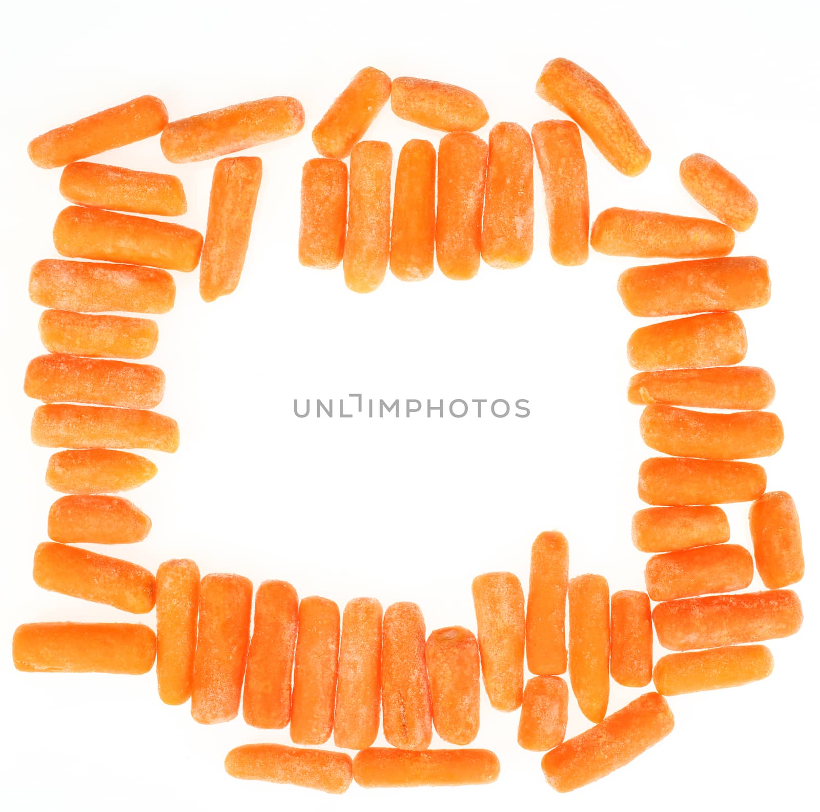 frame of frozen baby carrots over white