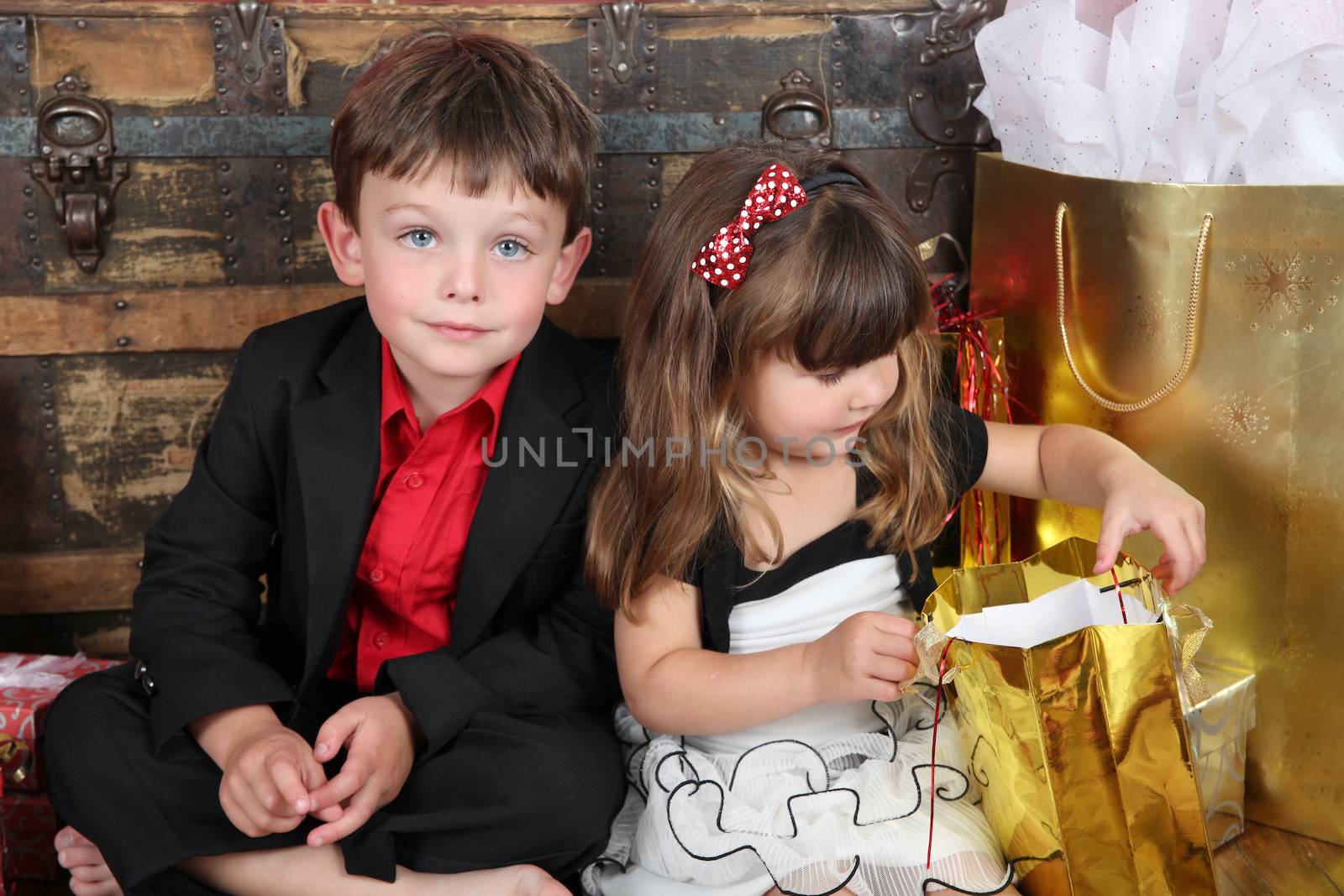Brother and sister against a wooden background on christmas day