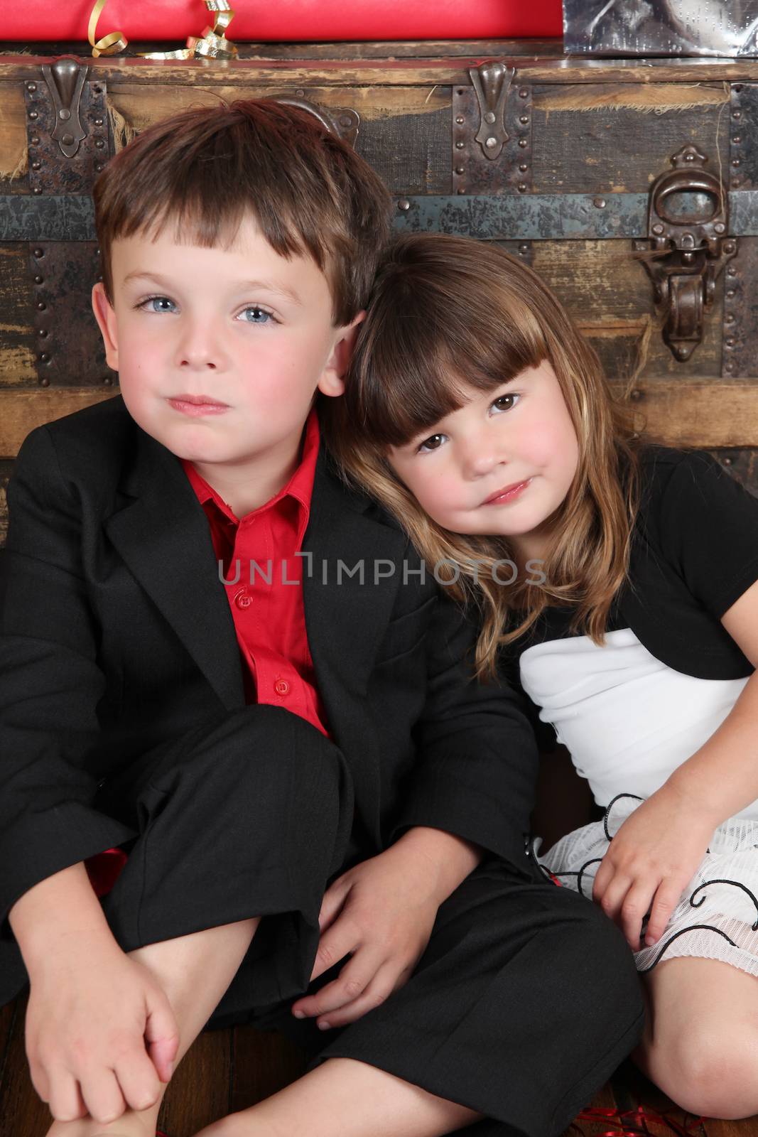 Brother and sister against a wooden background on christmas day