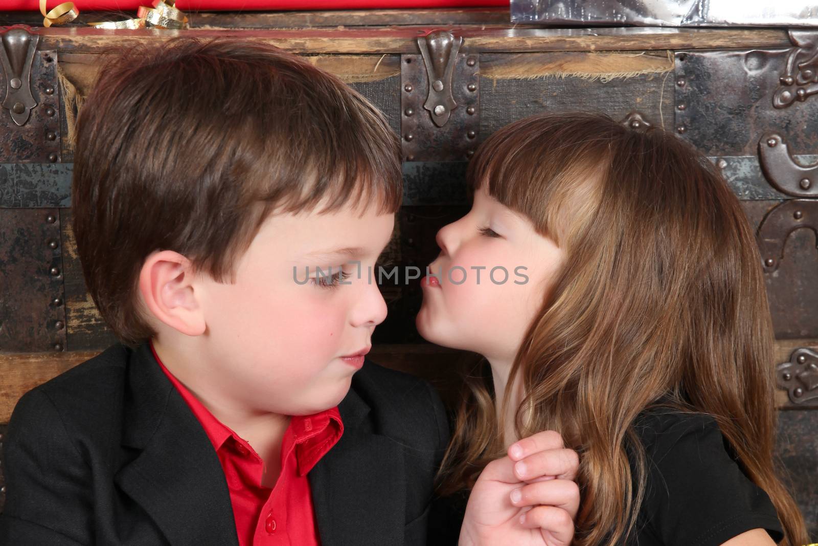 Brother and sister against a wooden background on christmas day