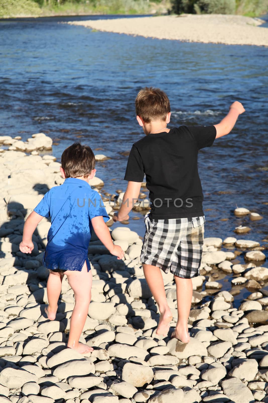 Two friends playing outside on pebble beach