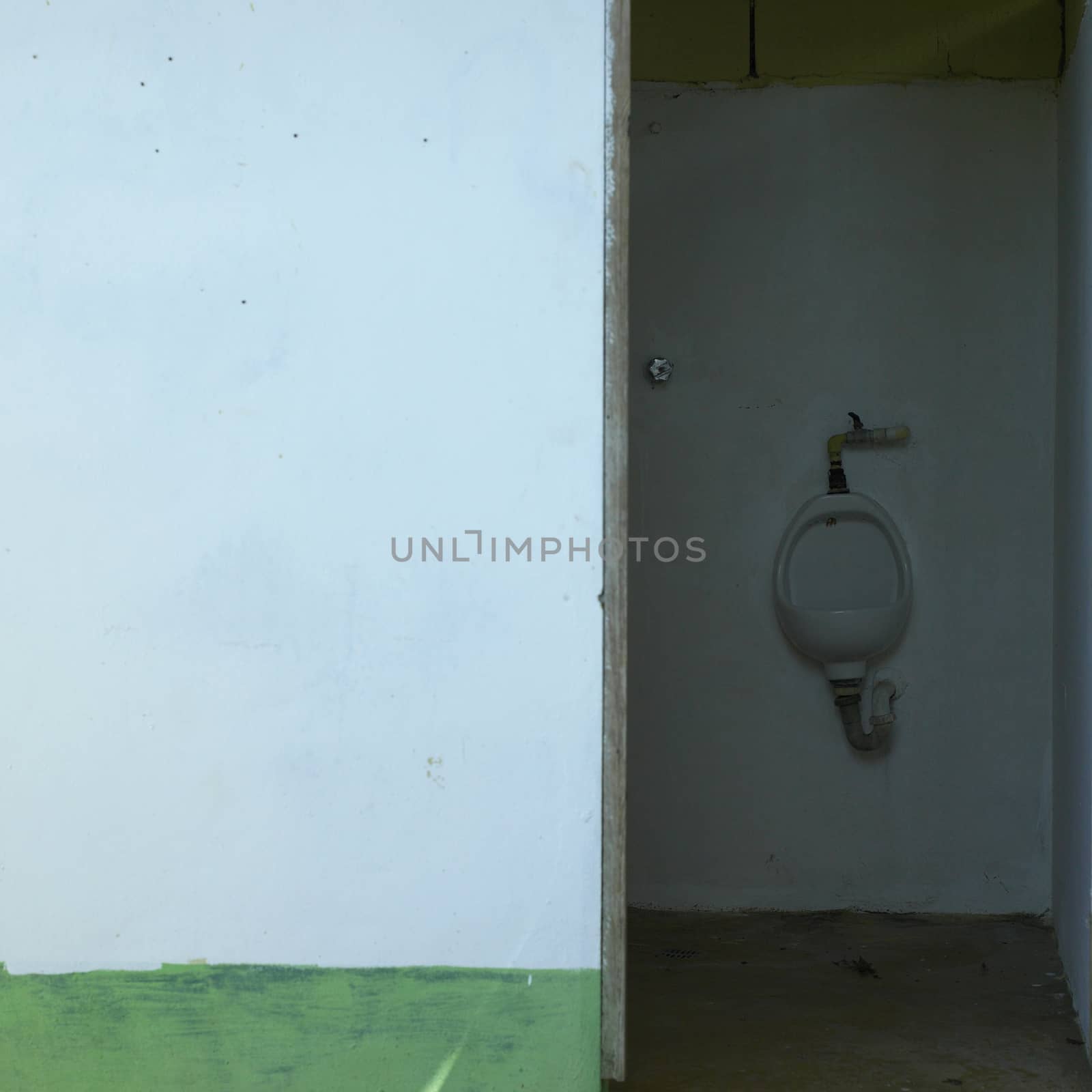 Urinal in a neglected washroom