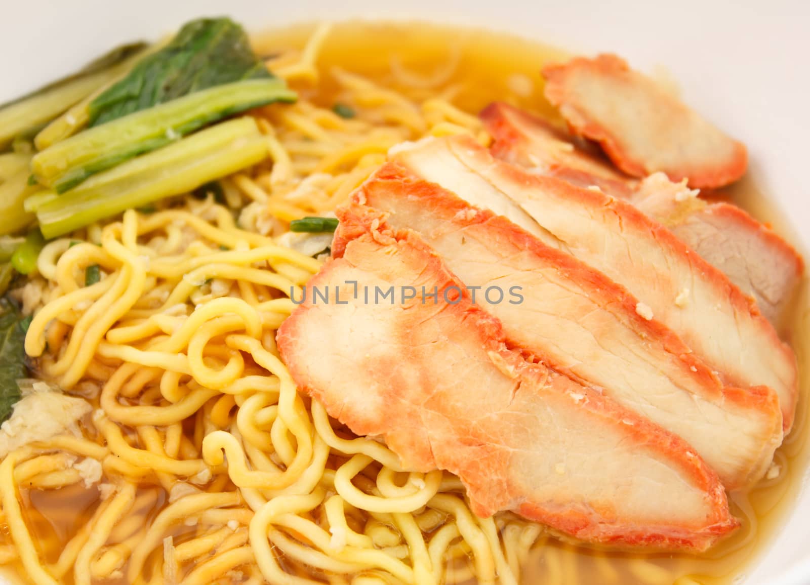 Chinese egg noodles with red pork in hot soup