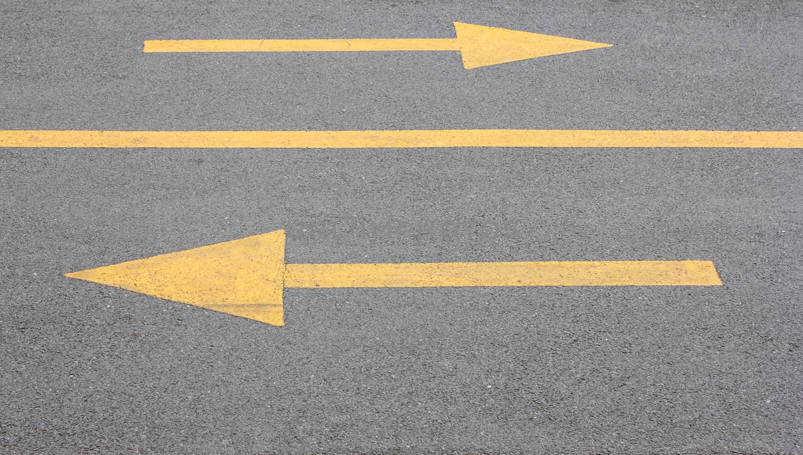 Yellow arrow right and left on asphalt street for the concept of choice
