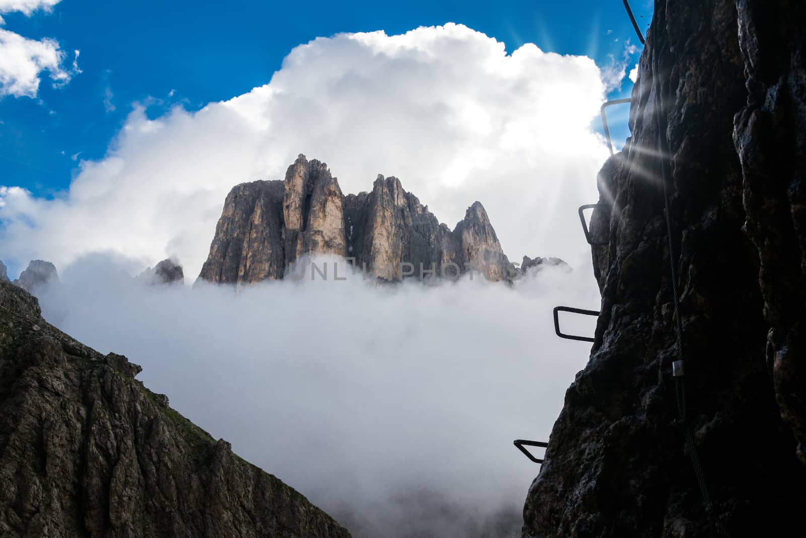 View of a via ferrata with mountains in background by enrico.lapponi