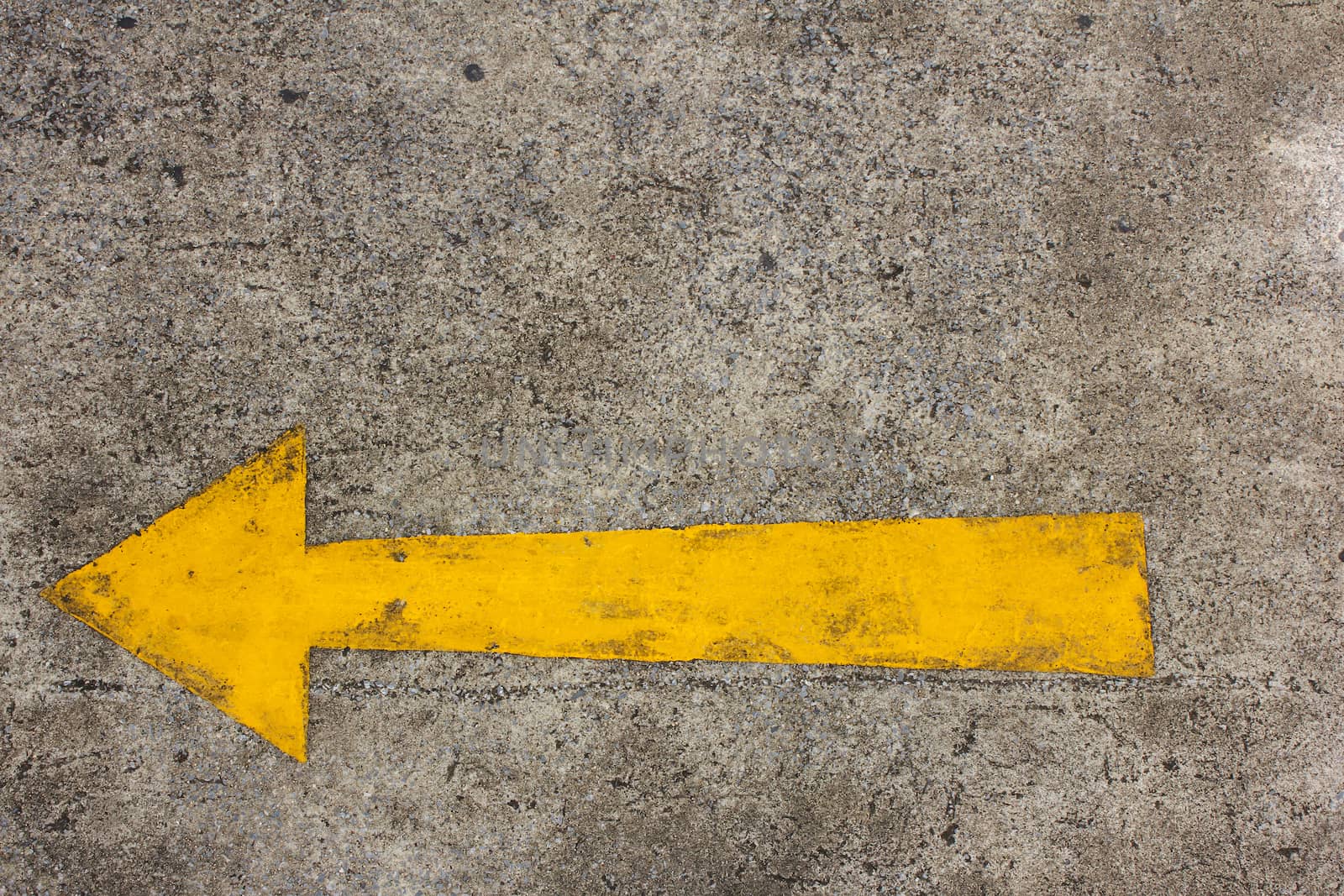 Yellow arrow left on asphalt street for the concept of choice