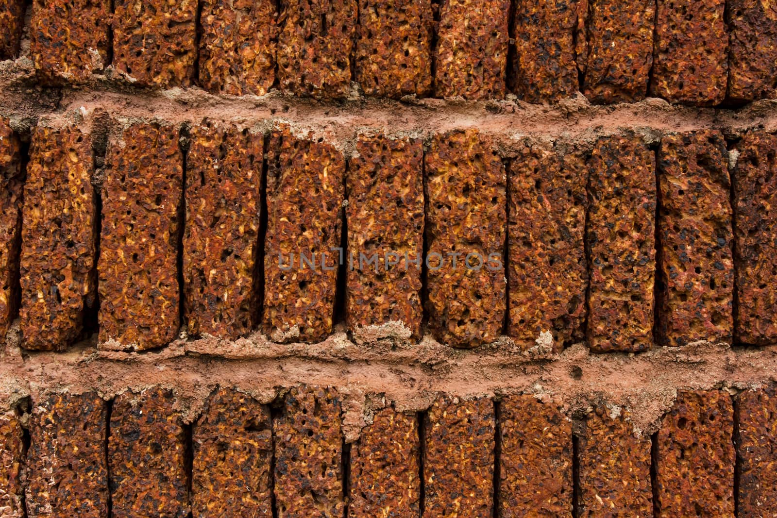 Red-brown laterite brick wall background
