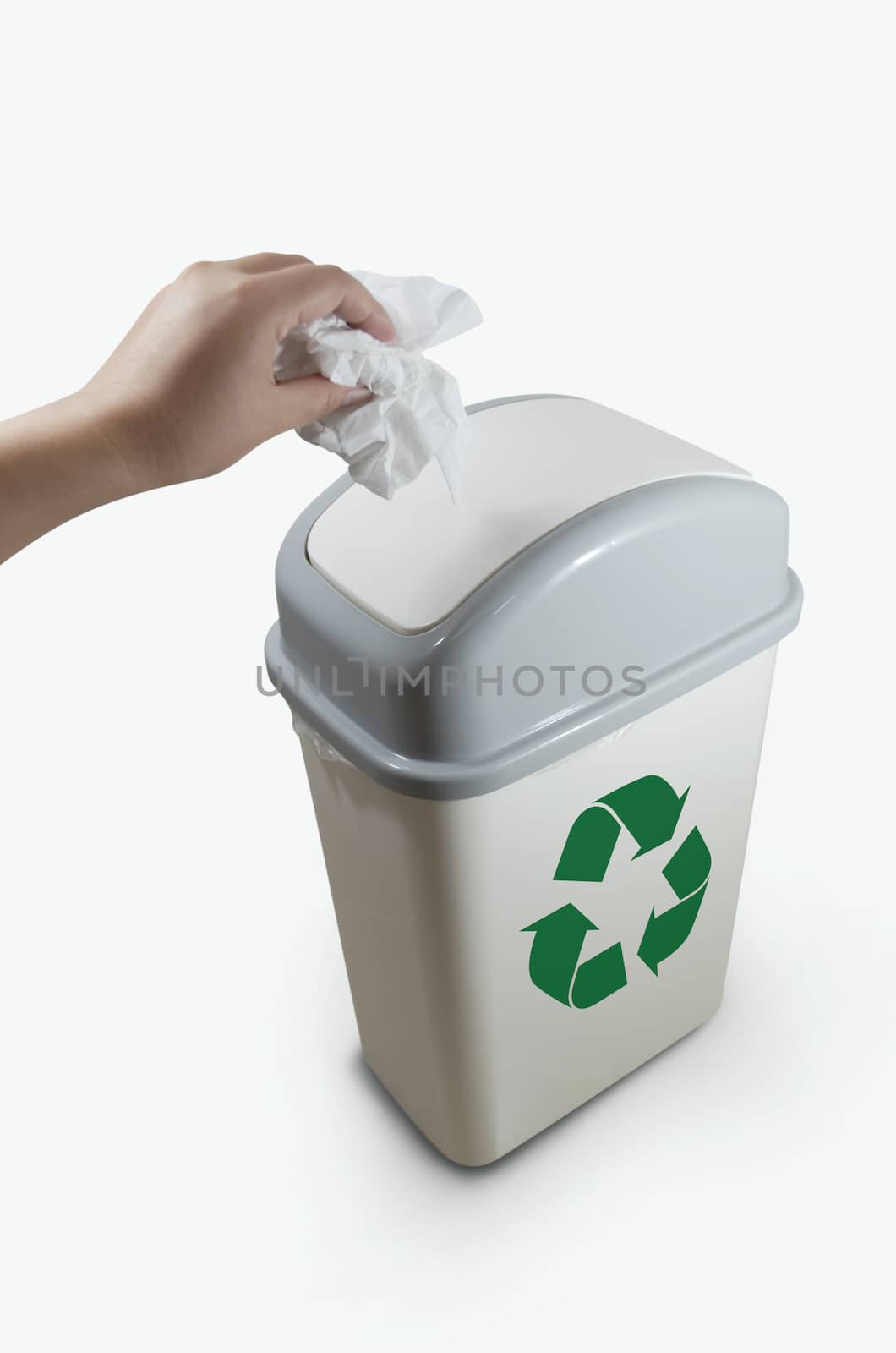 hand putting a paper garbage into recycling bin on white background