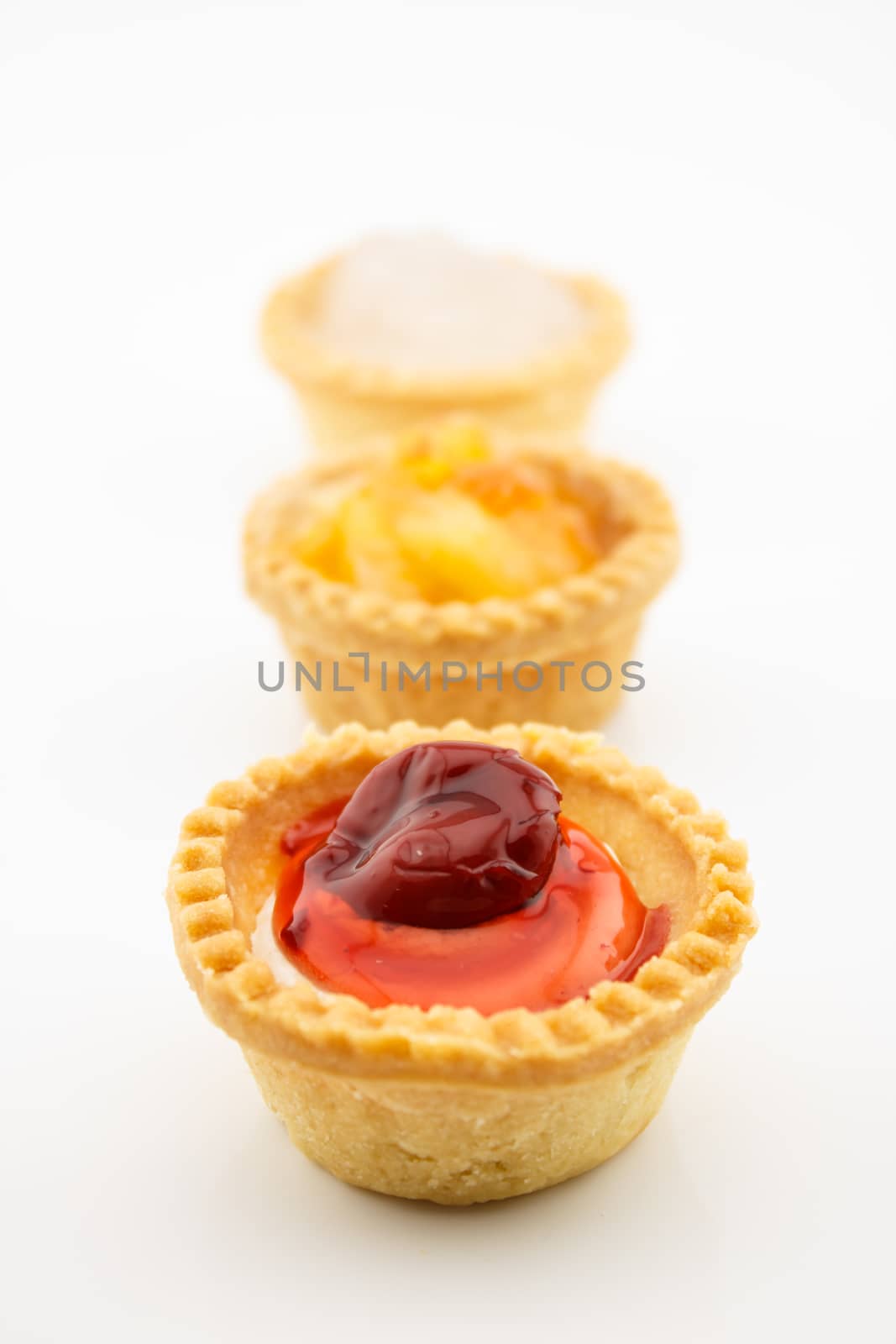 mini tart with red cherry jam isolated on white background