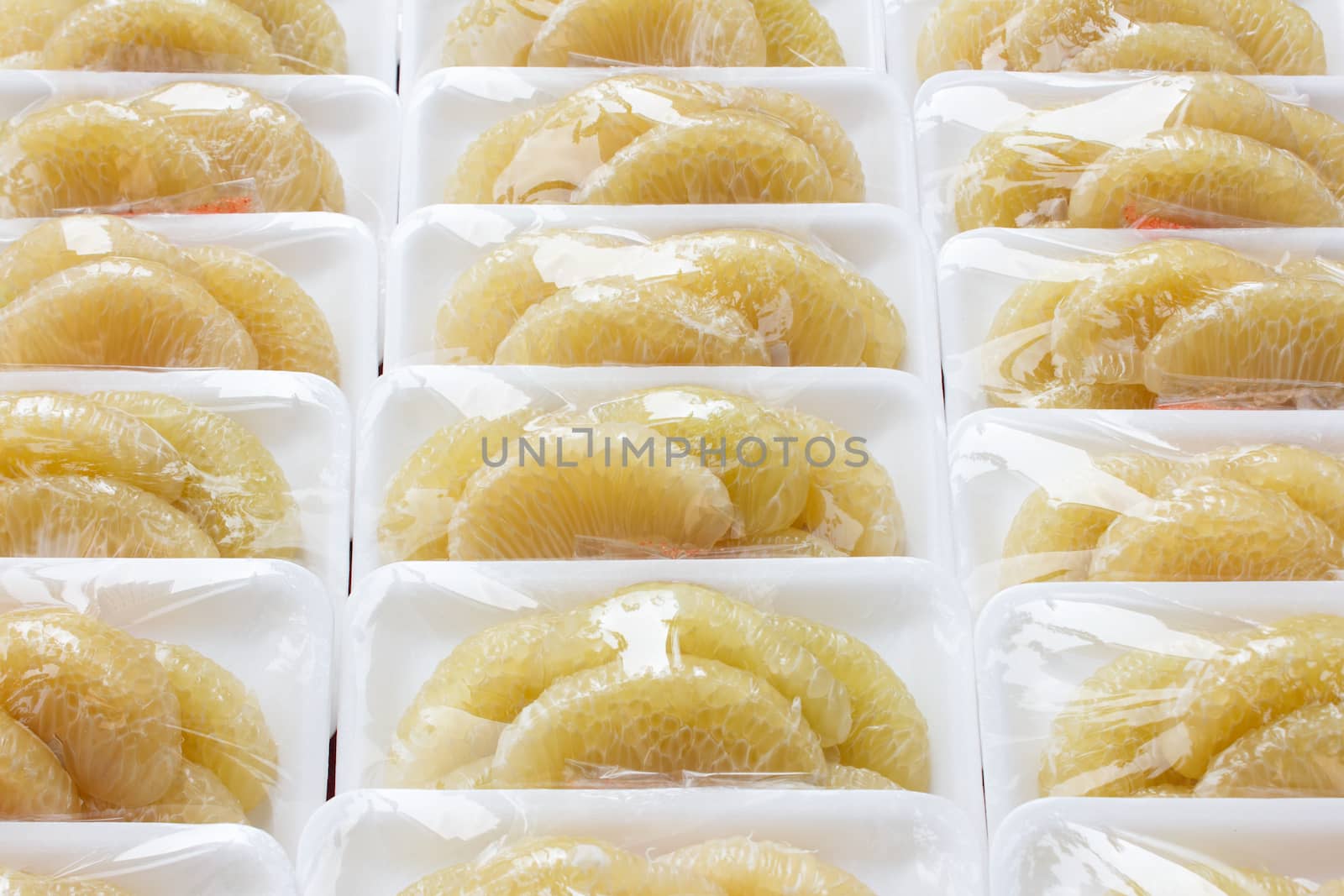 Peeled pomelo in plastic wrap at thai market