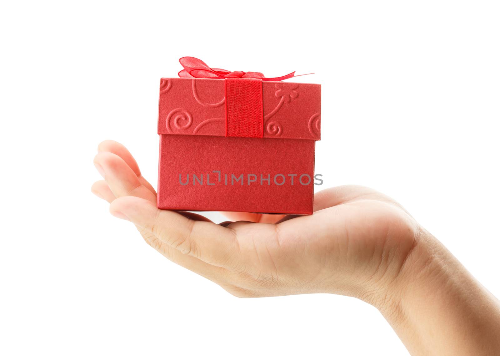 female hand holding red gift box on white background by vitawin
