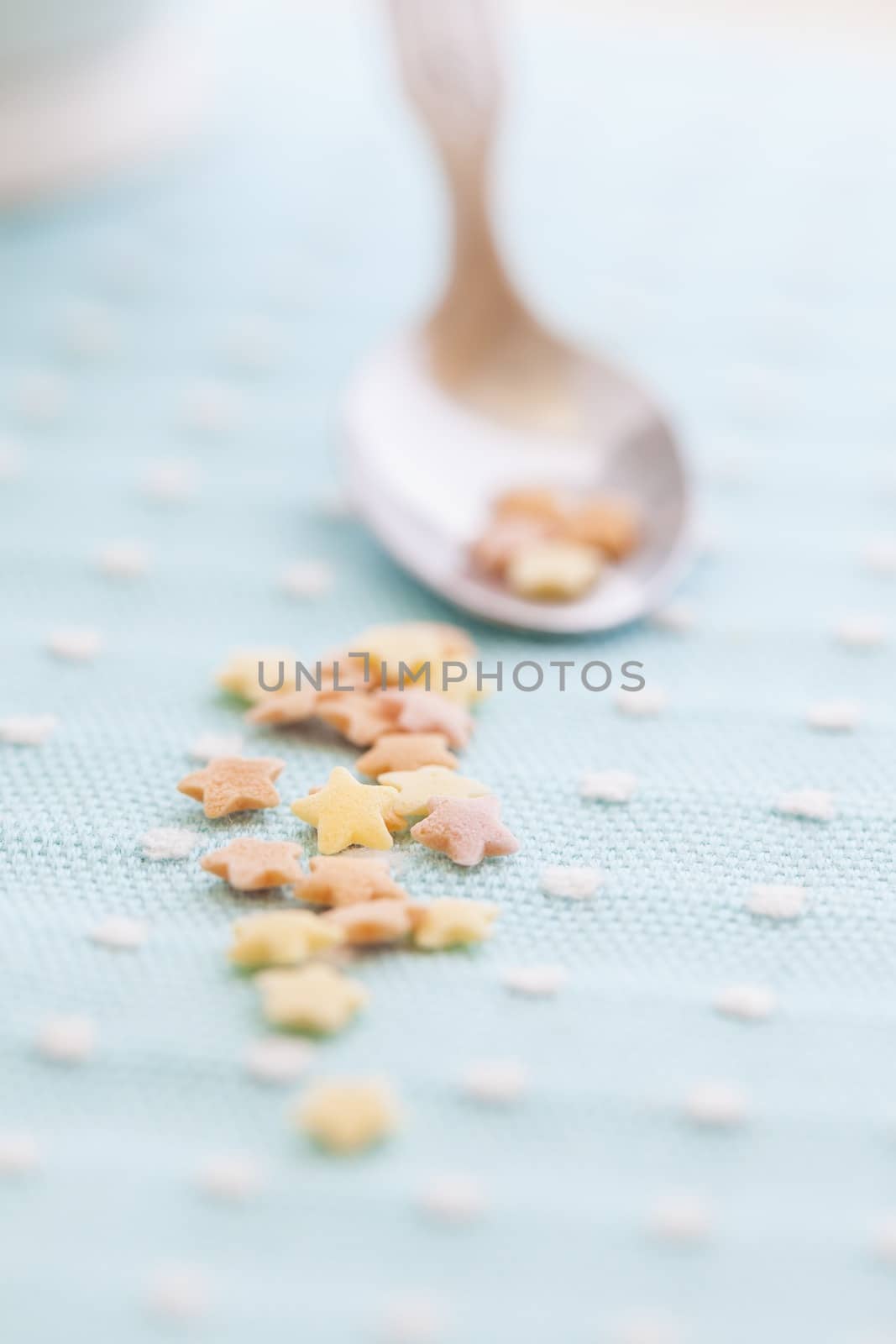 Cute picture of a spoon with star shaped candies