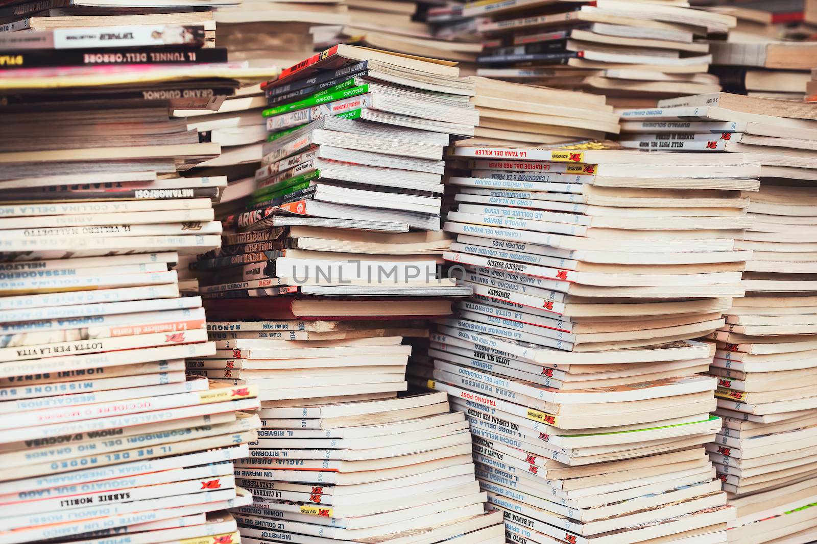 SANTA PORTO MARGHERITA, ITALY - JULY 27: Piles of Italian comics magazines TEX in a flea market on July 27, 2014. It is the most popular and enduring Italian comic book series of all time.