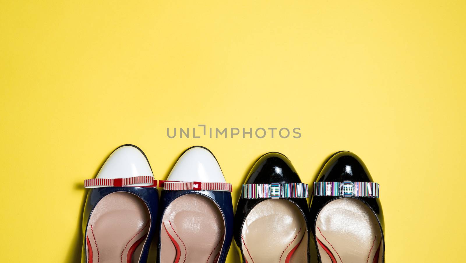 Leather woman shoes isolated on yellow background