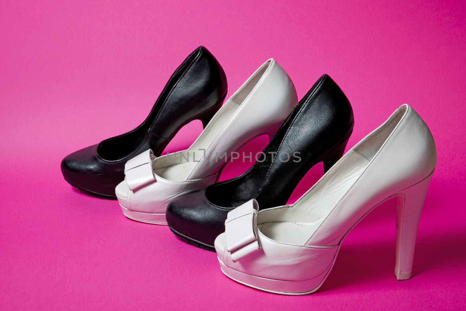 Woman shoes on pink background by marius_dragne