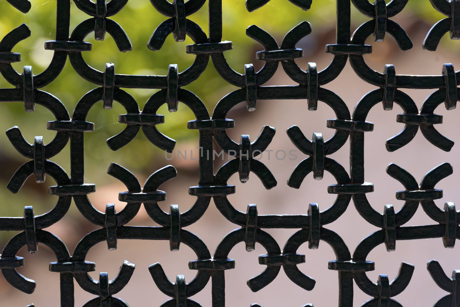 Silhouette of an old wrought iron fence painted with black color