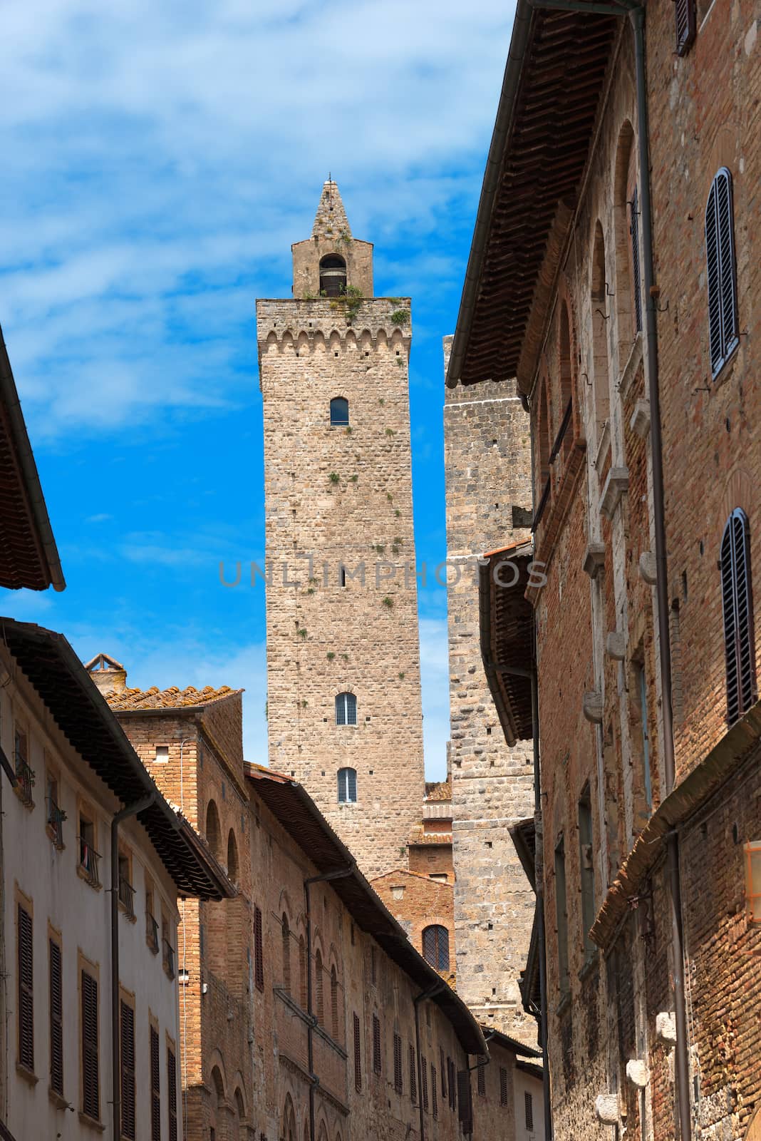 The Torre Grossa view from a street in the center of San Gimignano medieval town (UNESCO heritage), Siena, Tuscany, Italy