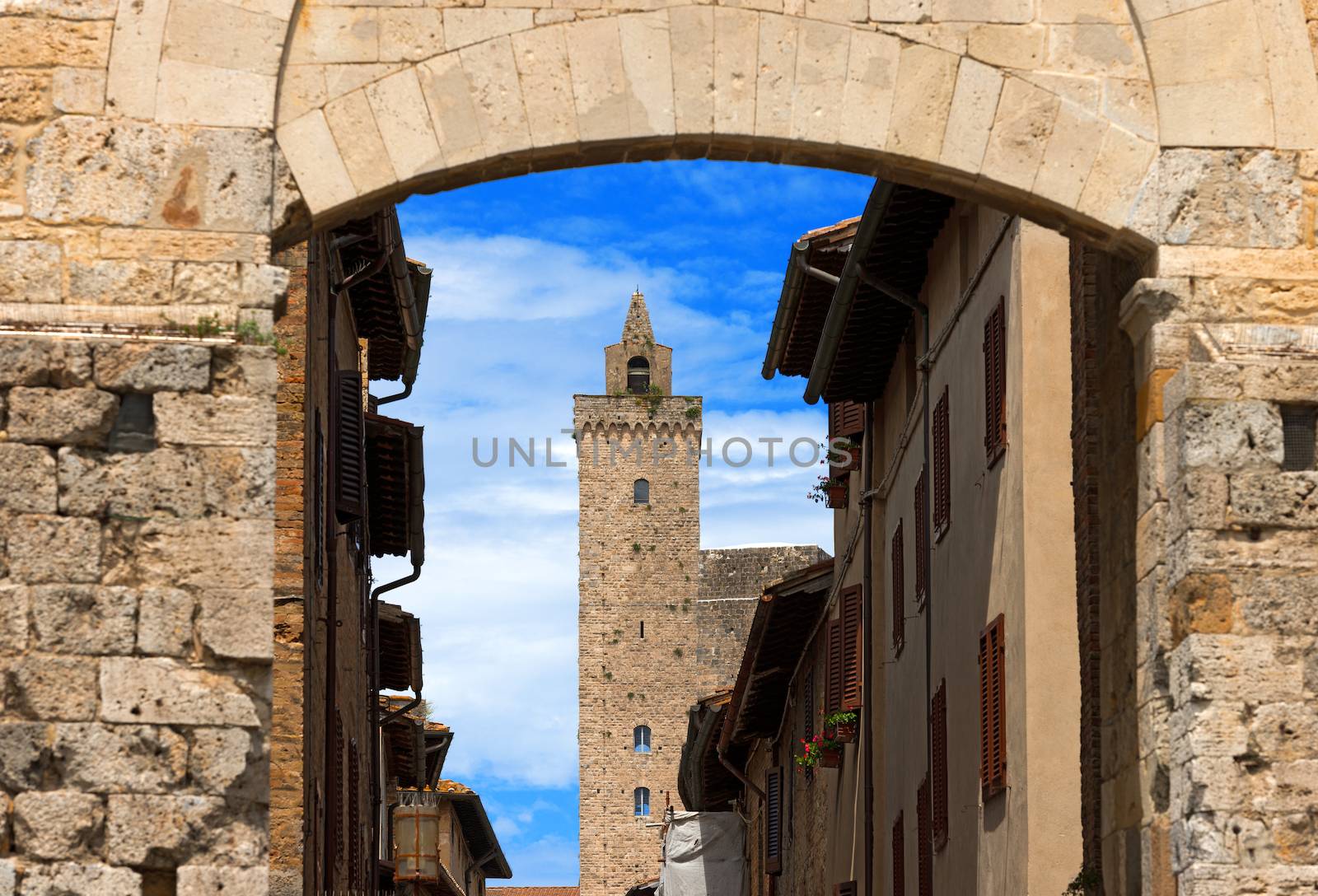 The Torre Grossa view through Porta San Giovanni in San Gimignano medieval town (UNESCO heritage), Siena, Tuscany, Italy