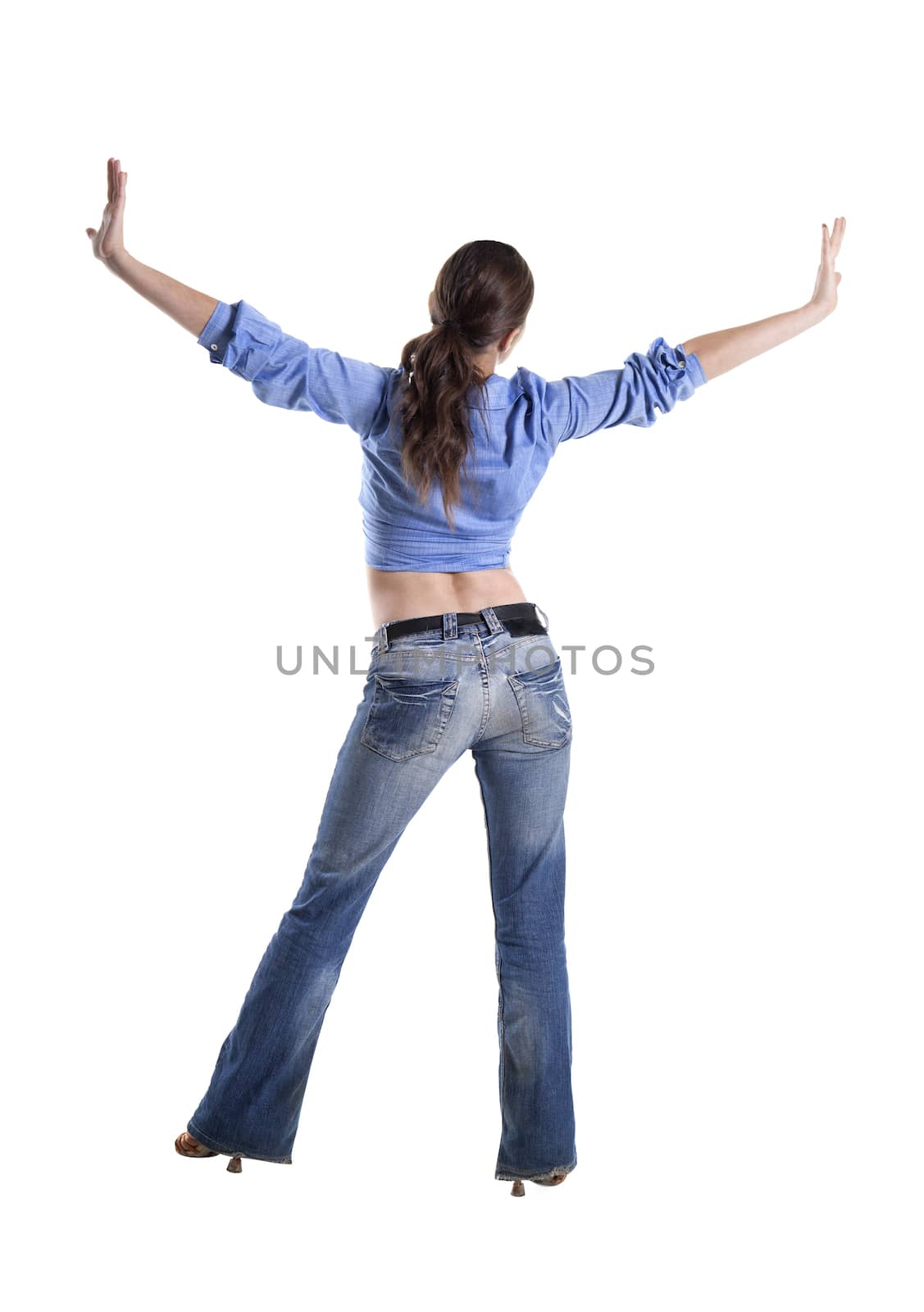 Back view of a young woman, arms extended sideways