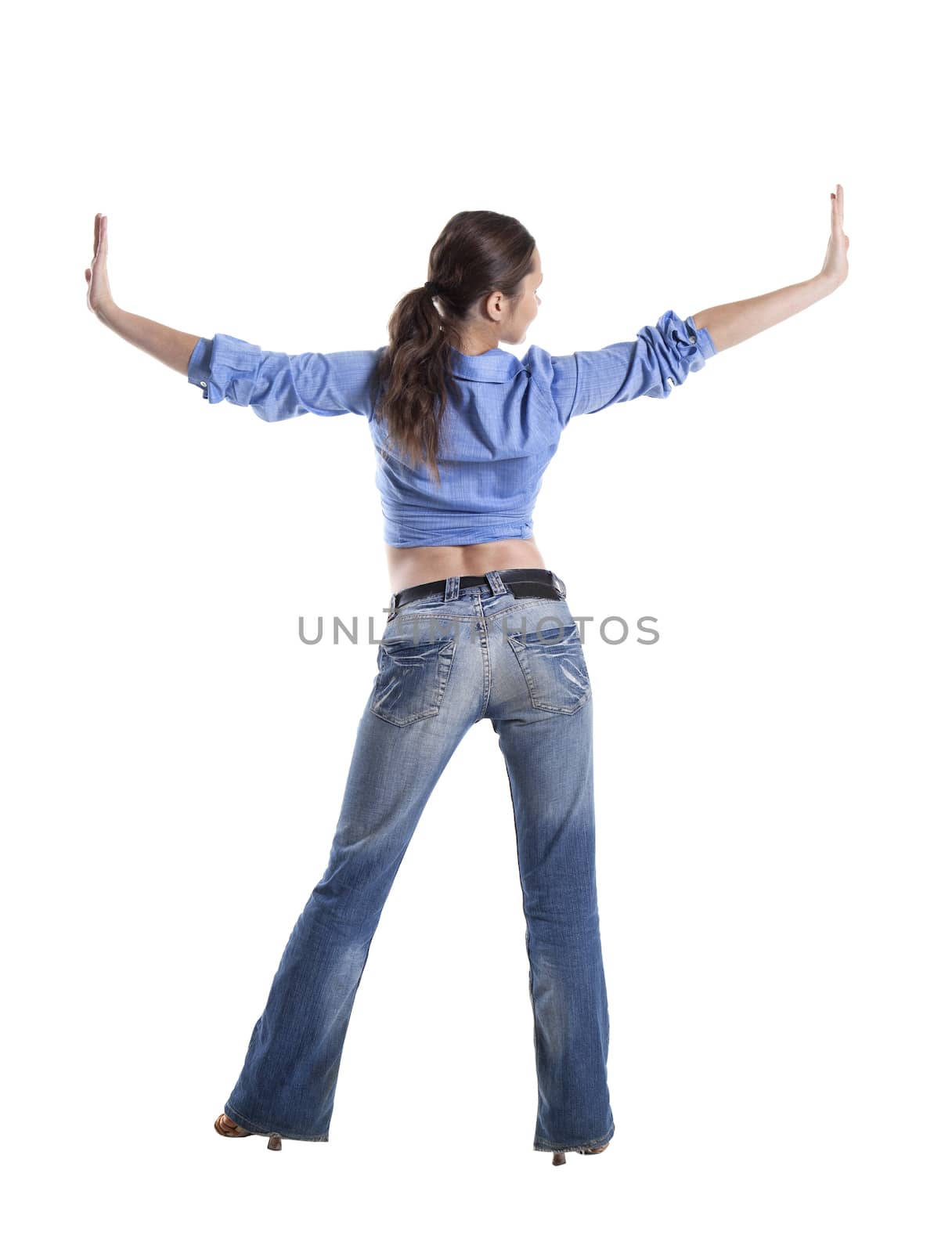 Back view of a young woman, arms extended sideways