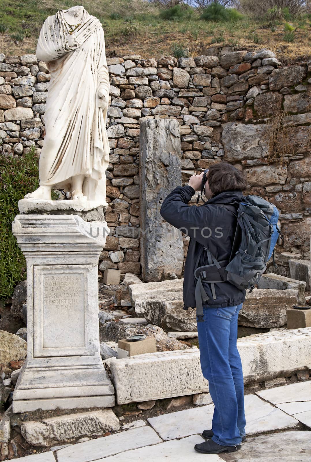 Tourist with a photo camera in Ephesus, Turkey