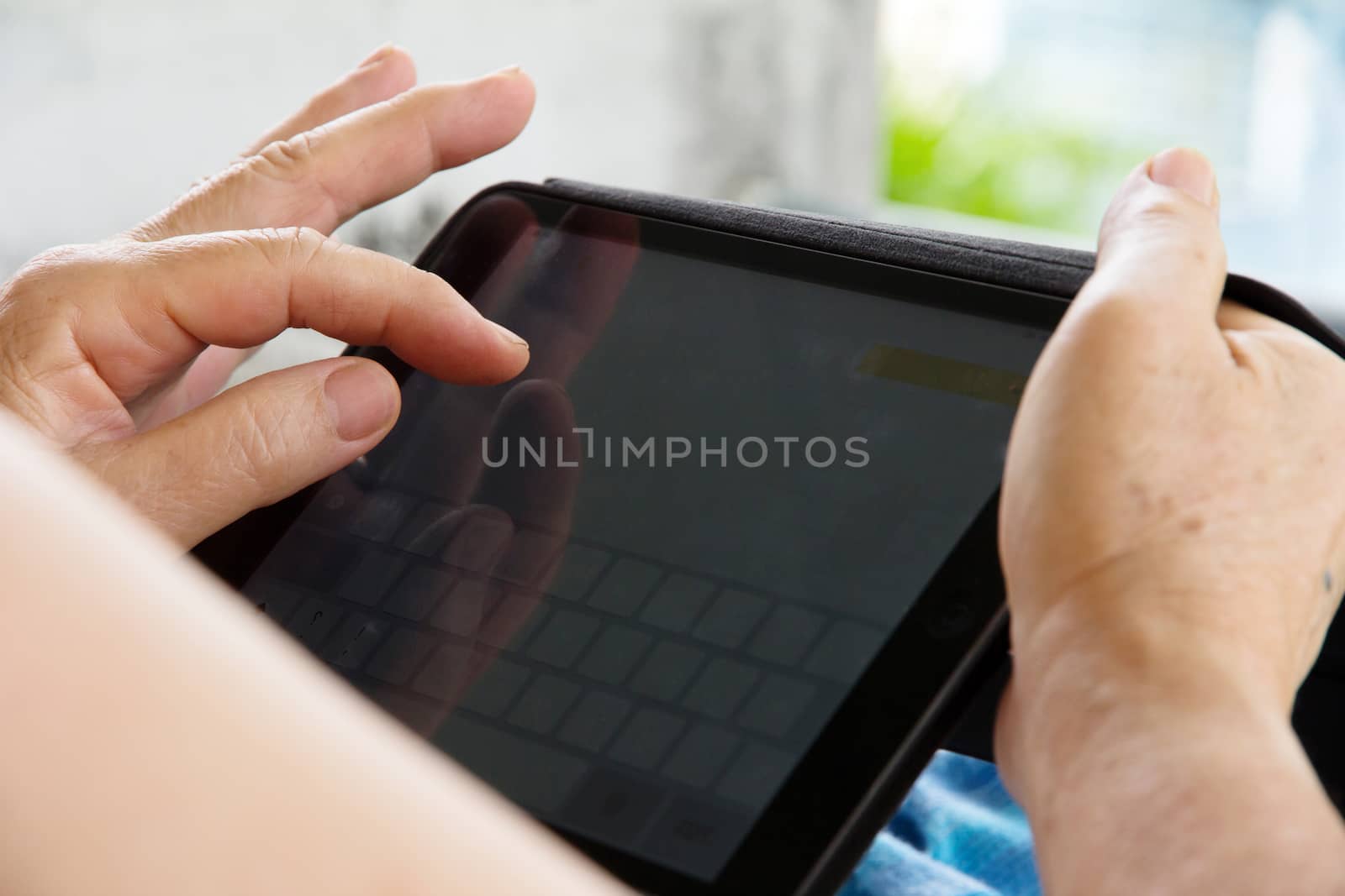 Senior woman using tablet at home