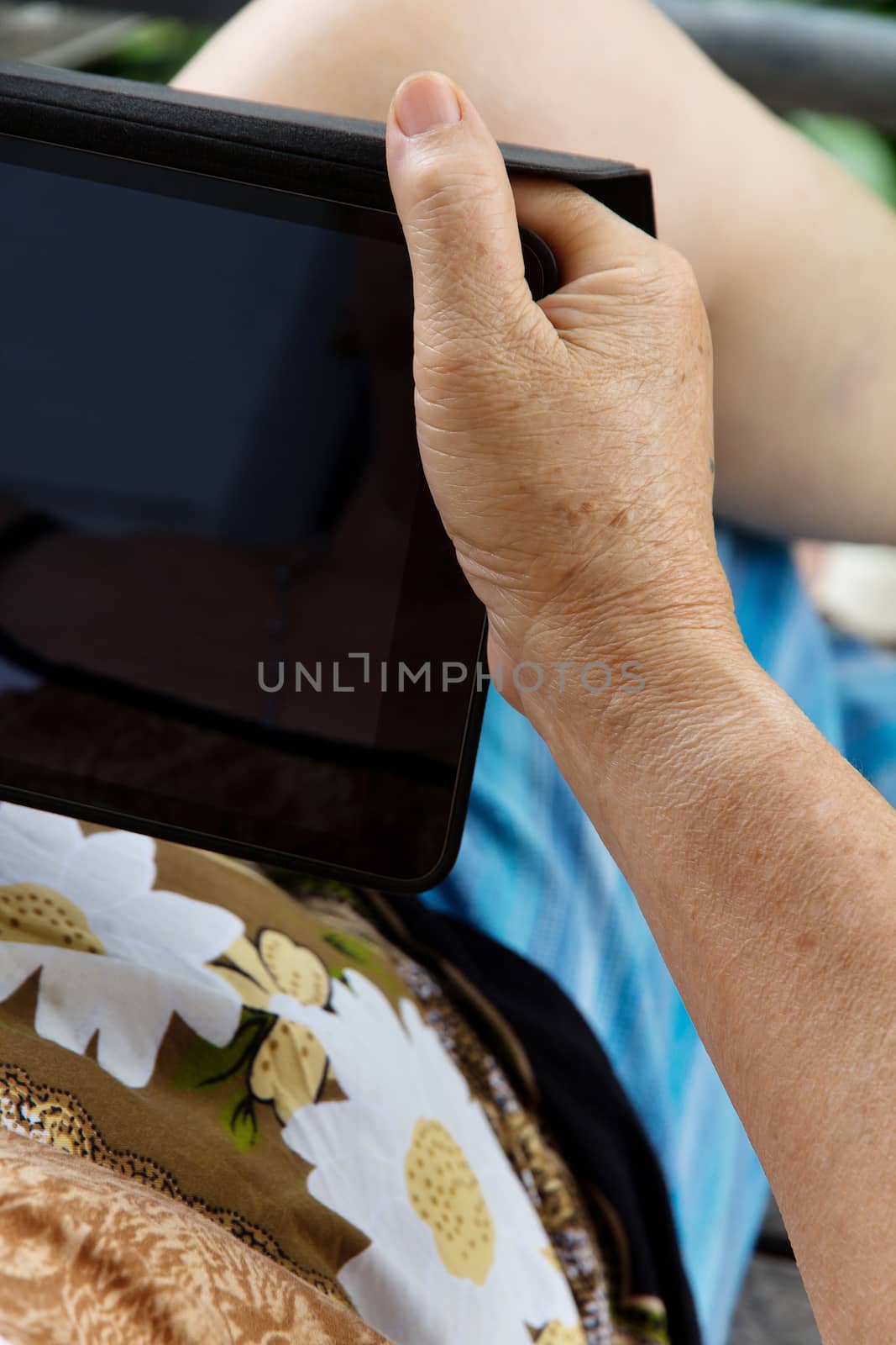 Senior woman using tablet at home