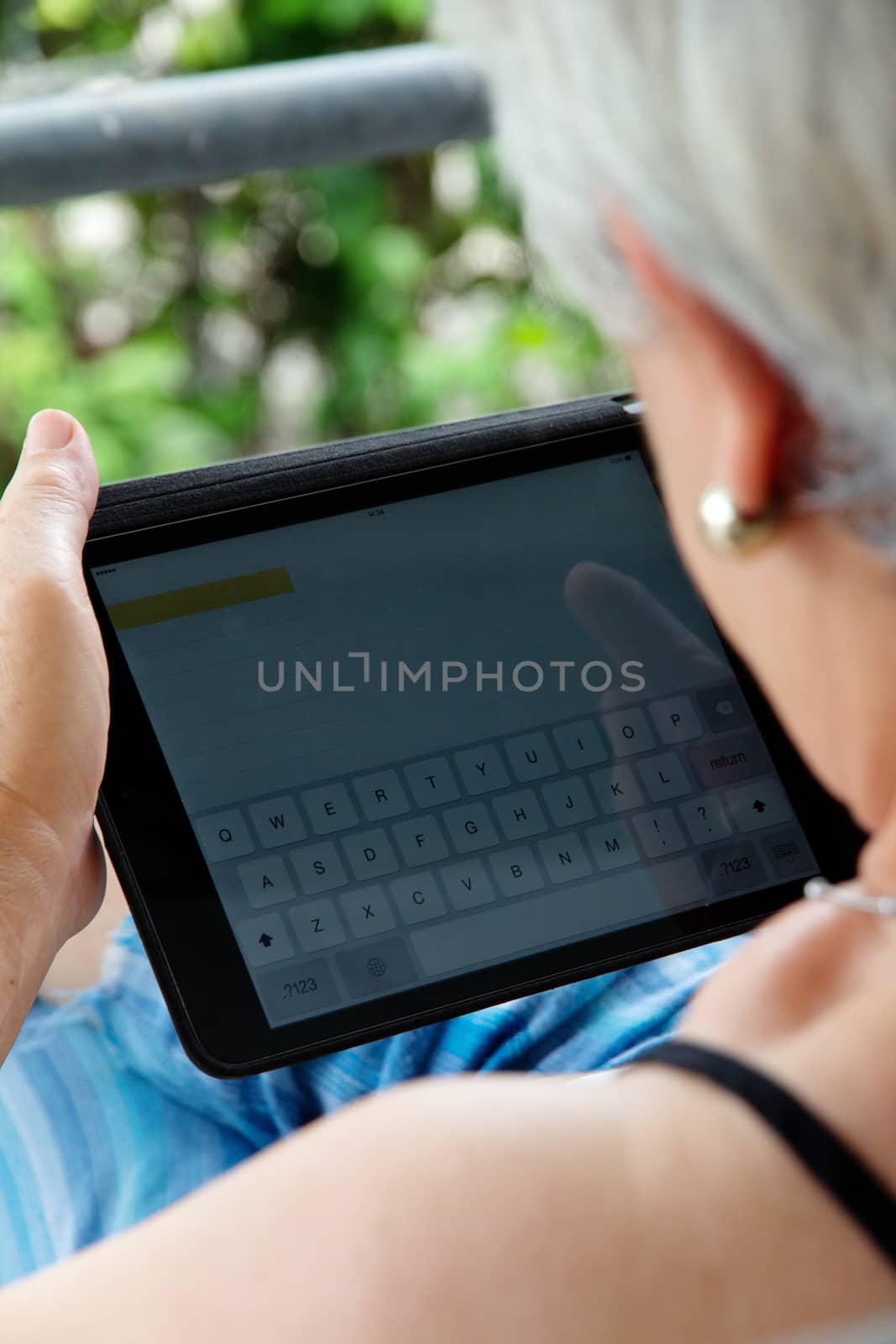 Senior woman with tablet by ponsulak