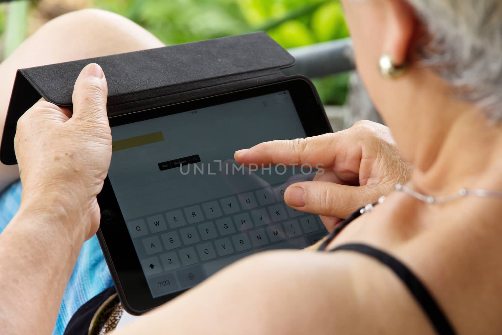 Senior woman using tablet at home