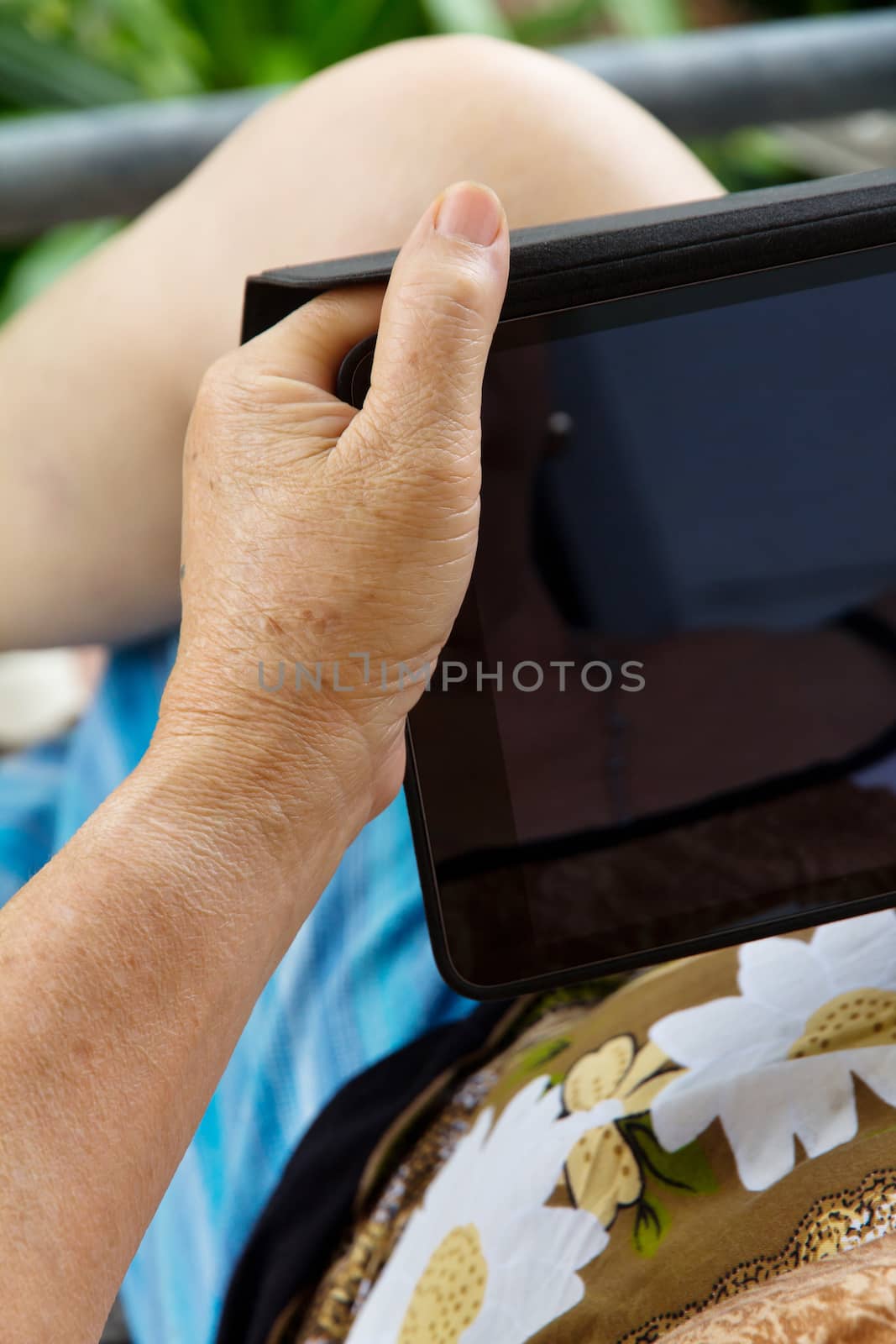 Senior woman using tablet at home