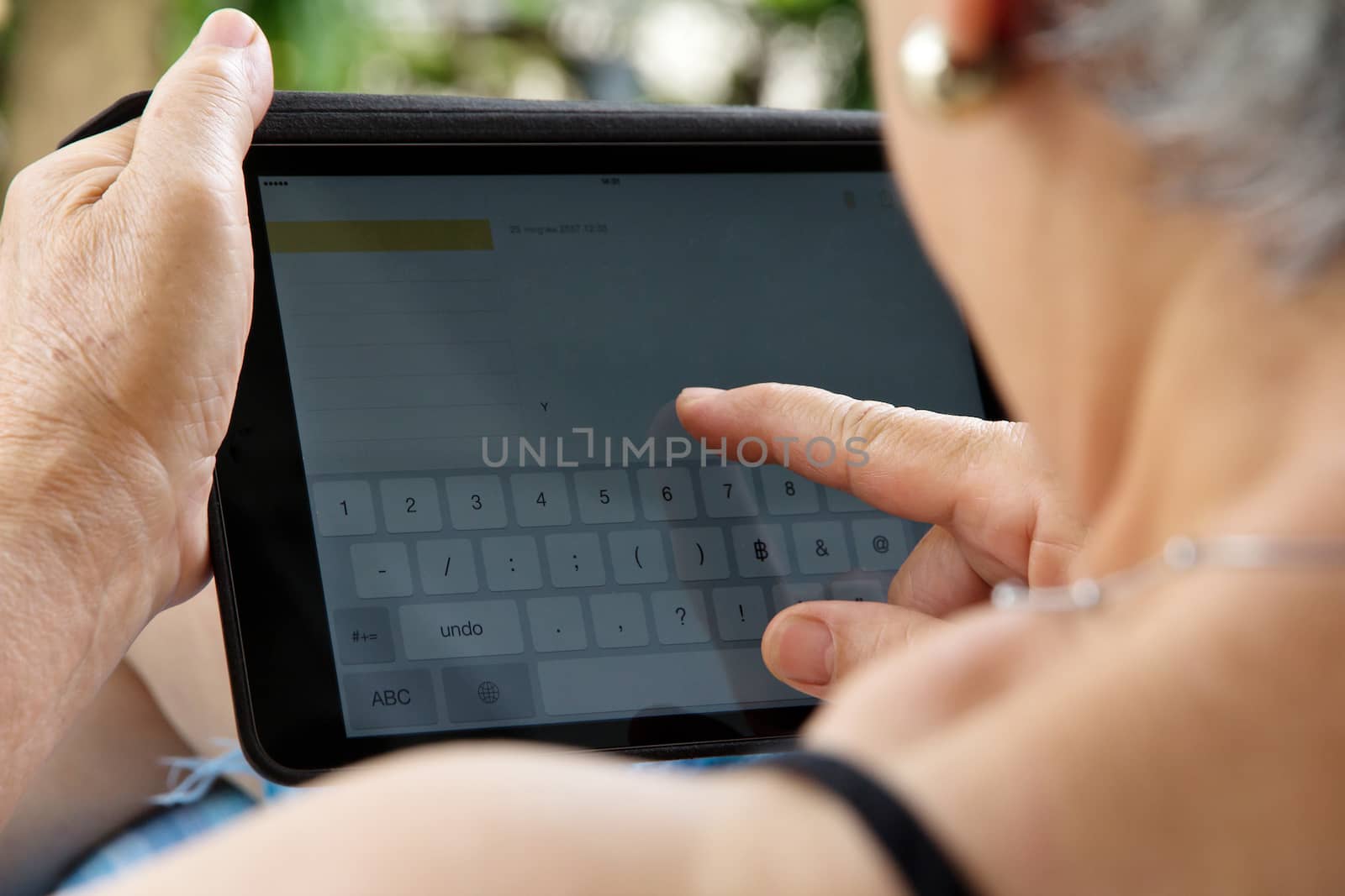Senior woman using tablet at home