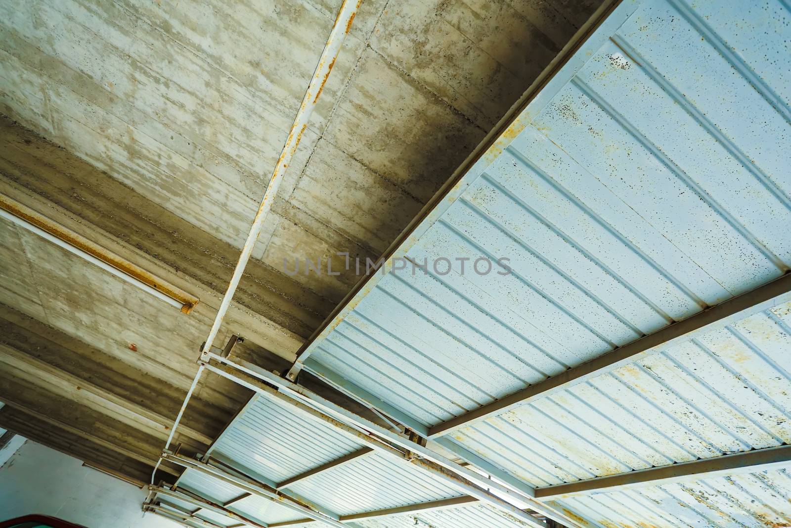 A industrial garage ceiling with open gates.