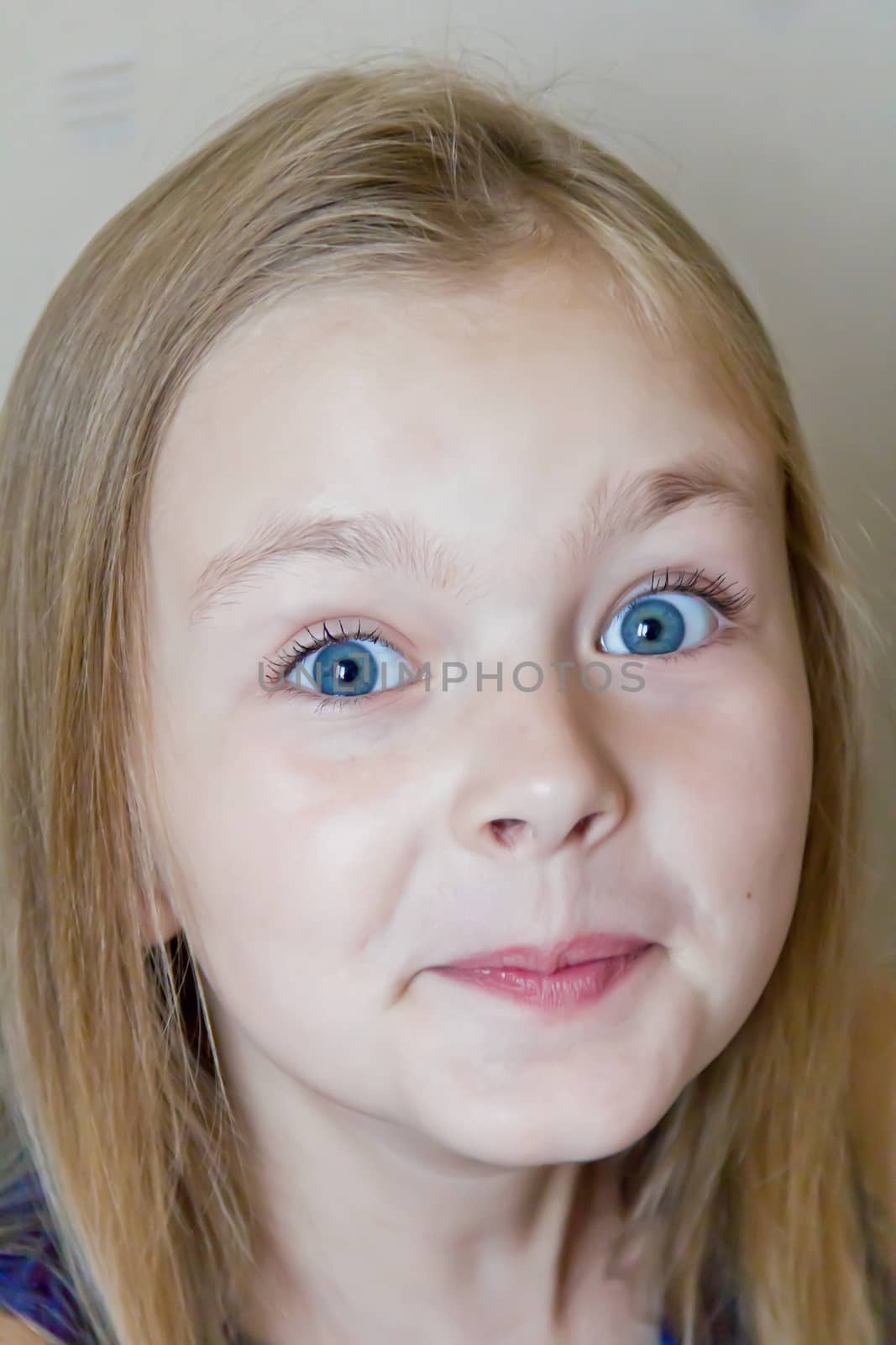 Photo of surprised cute girl with blond hair