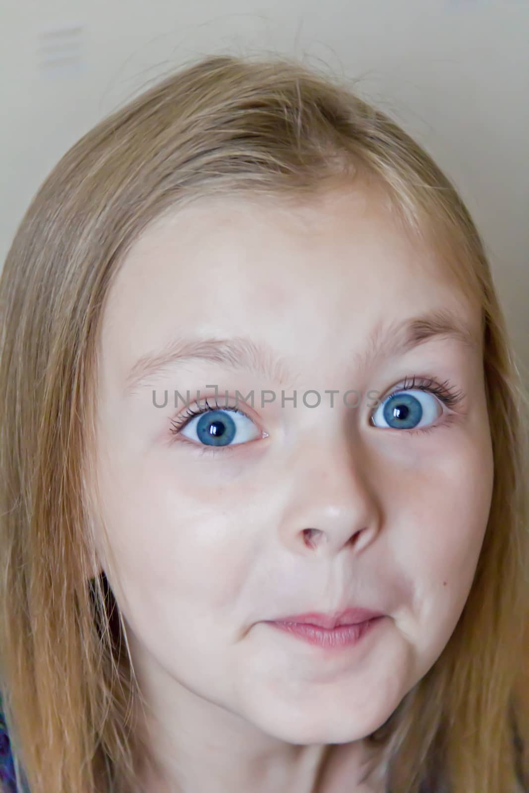 Photo of surprised cute girl with blond hair